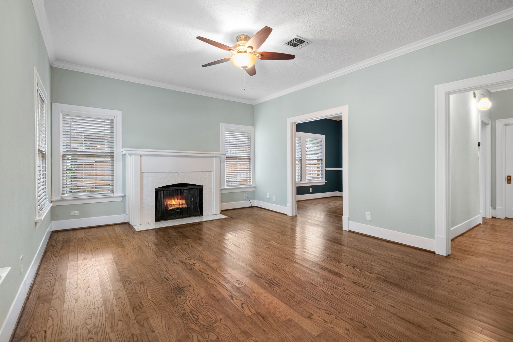 Walking into this classic 1924 bungalow, you are greeted by the warm living area with a charming wood burning fireplace.  Oak flooring was installed to keep the charm of this home.