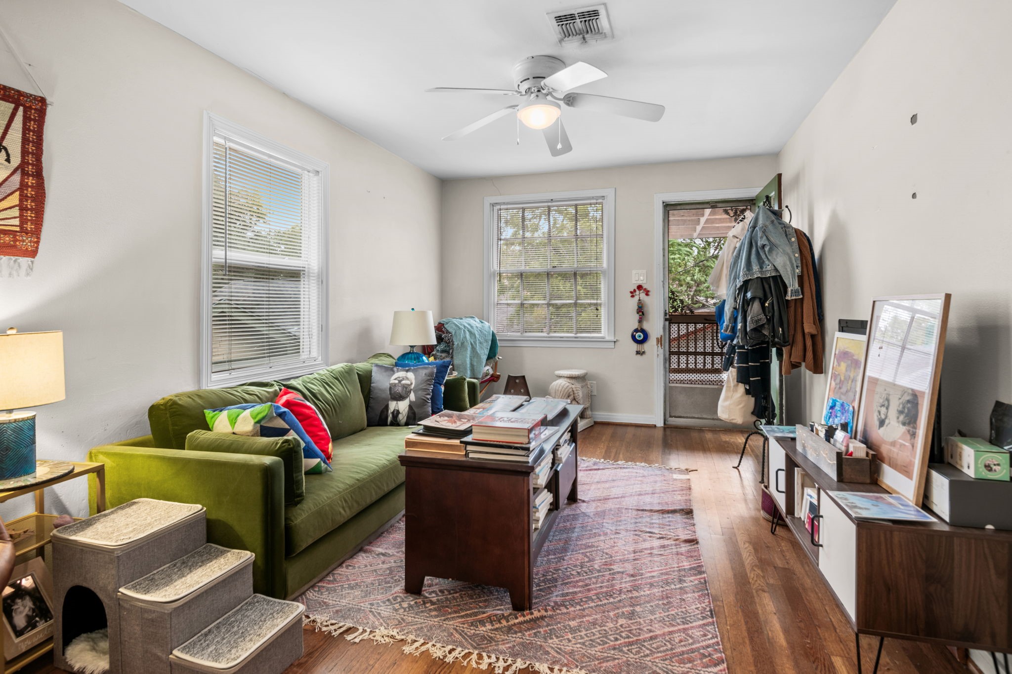 Wood floors run throughout the garage apartment with sunny tree top views from the windows.