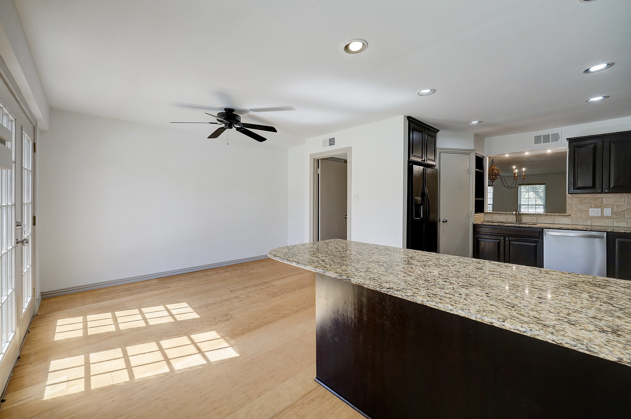 Alternate view of the back entrance, and sizable breakfast room. A well-placed ceiling fan allows for easy air flow.