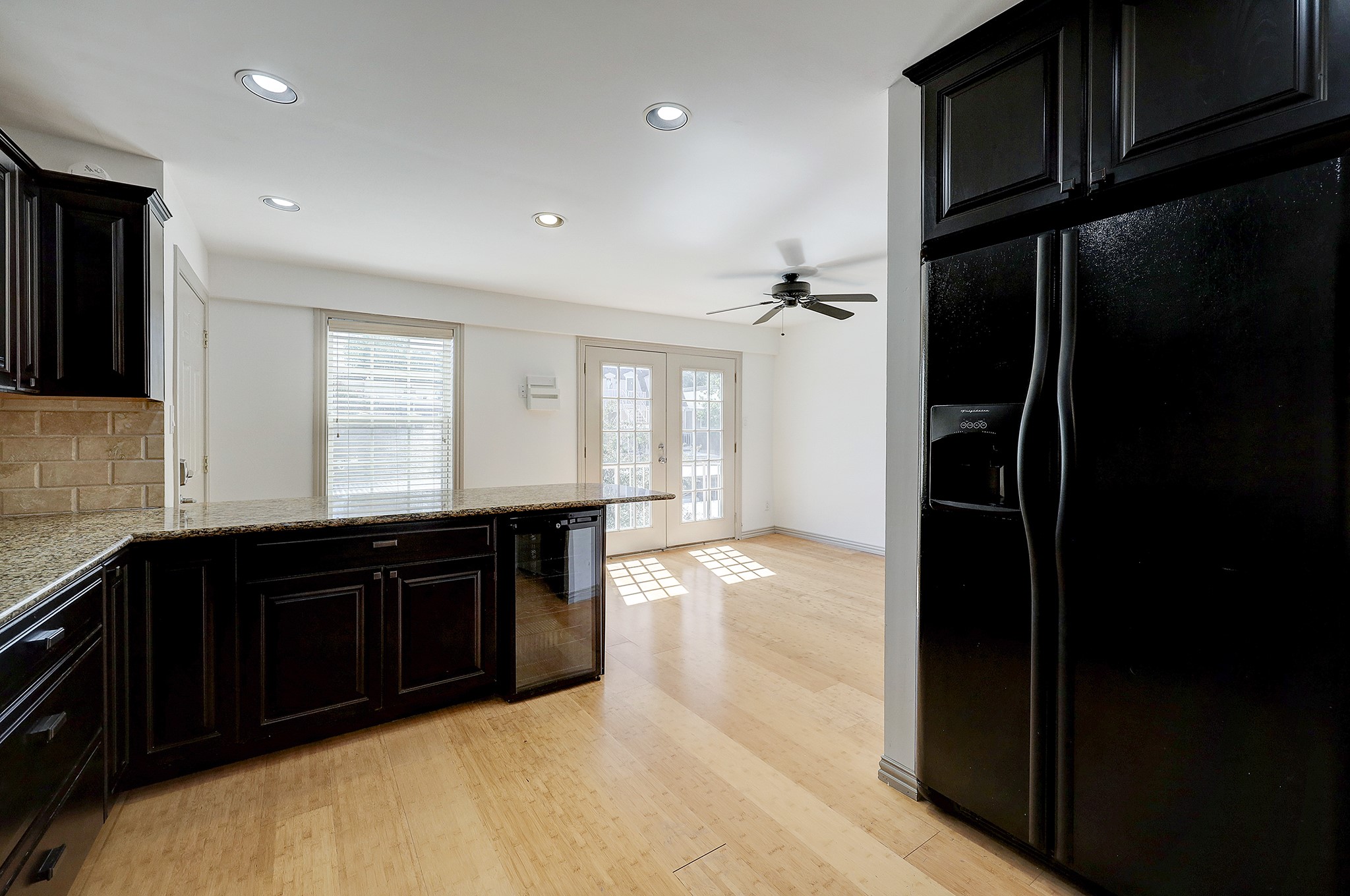 Alternate view of the chef's space. A large breakfast bar offers a perfect place for a casual meal. A wine cooler is conveyed in the sale of the home.