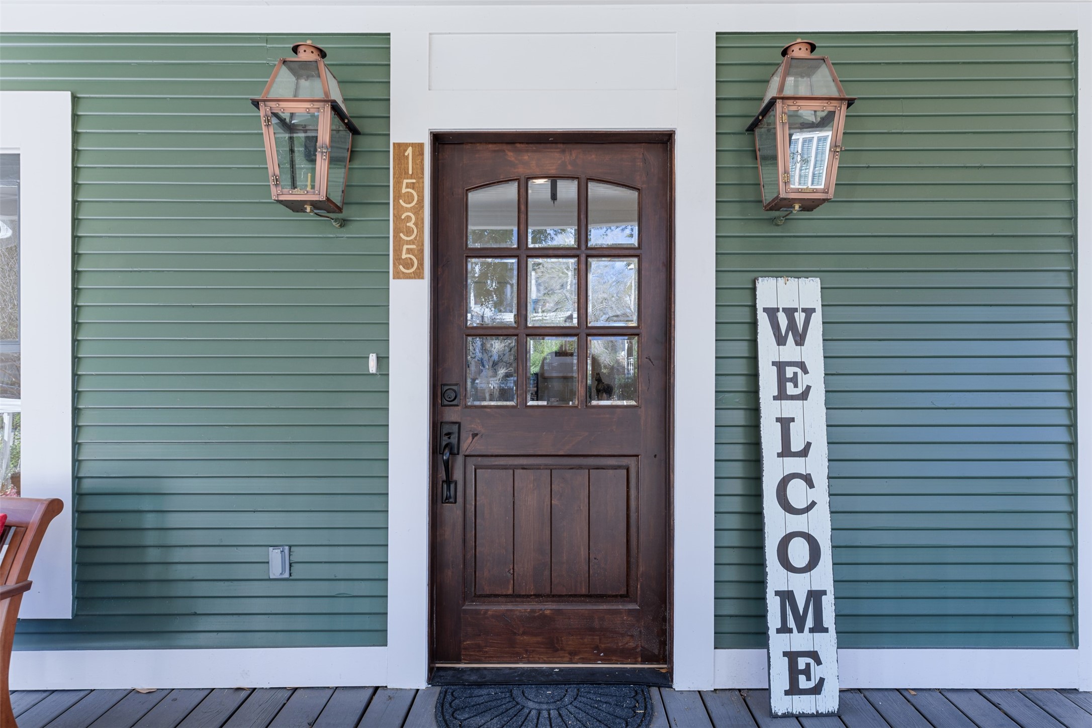 The beautiful front porch provides an inviting space to relax and unwind at the end of the day.  The copper gas lanterns add both charm and character perfectly showcasing the beautiful rendition of this impressive Victorian historic renovated property.