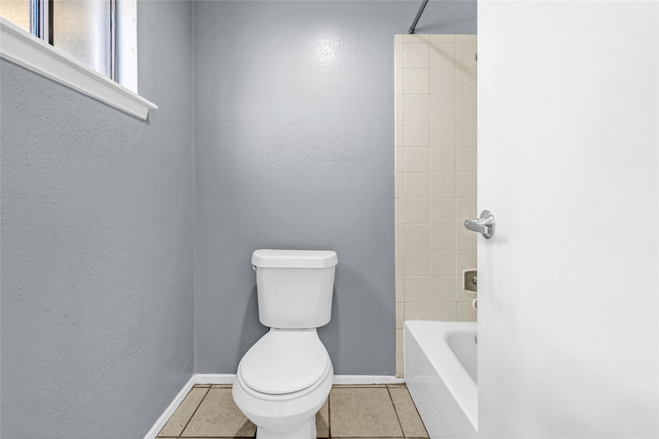 Clean and neutral, the primary bathroom awaits your personal touch.