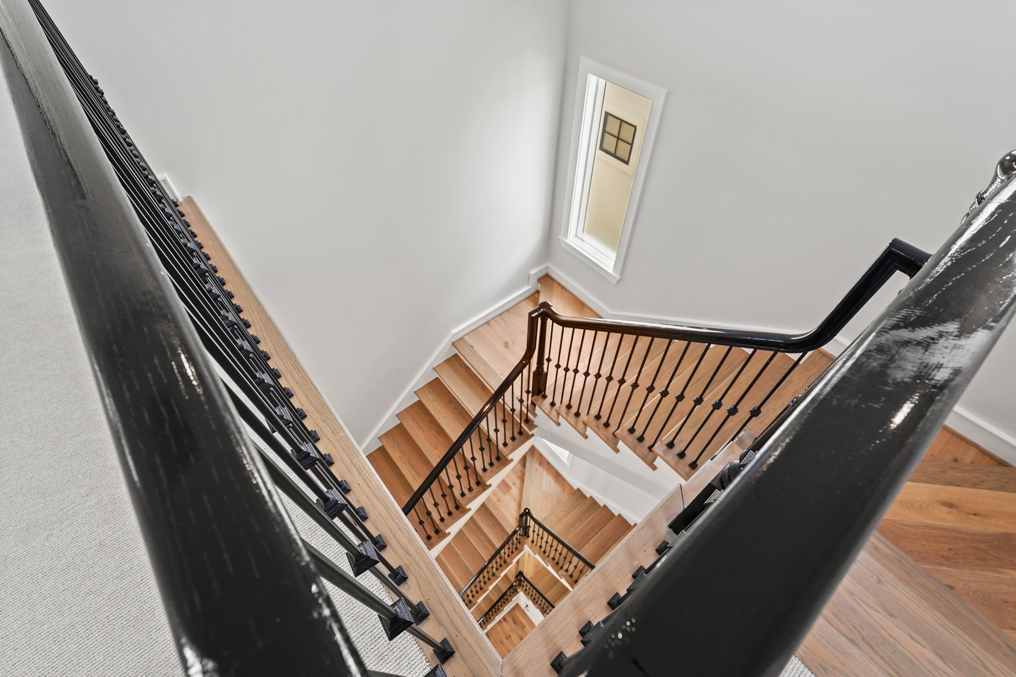 Your Dramatic Open Staircase is Gorgeously Contrasted By Hardwood Warmth & Timeless Espresso Colored Railing & Spindles