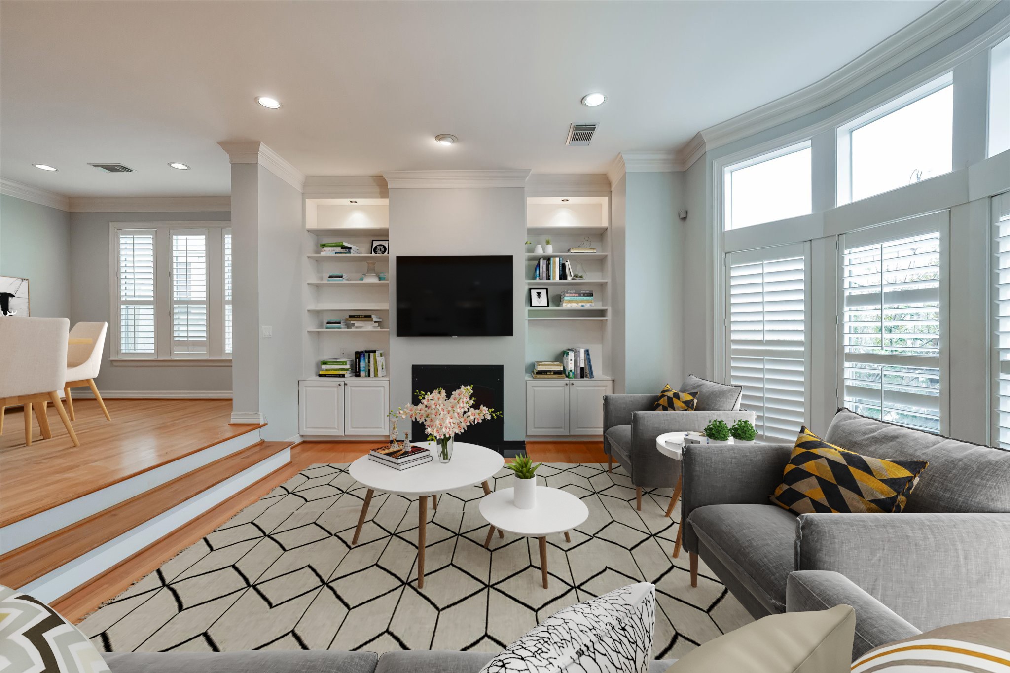 Welcome to your second-floor living area. This space is truly exquisite with bay area windows, recessed lighting, built-in shelving, and crown molding.