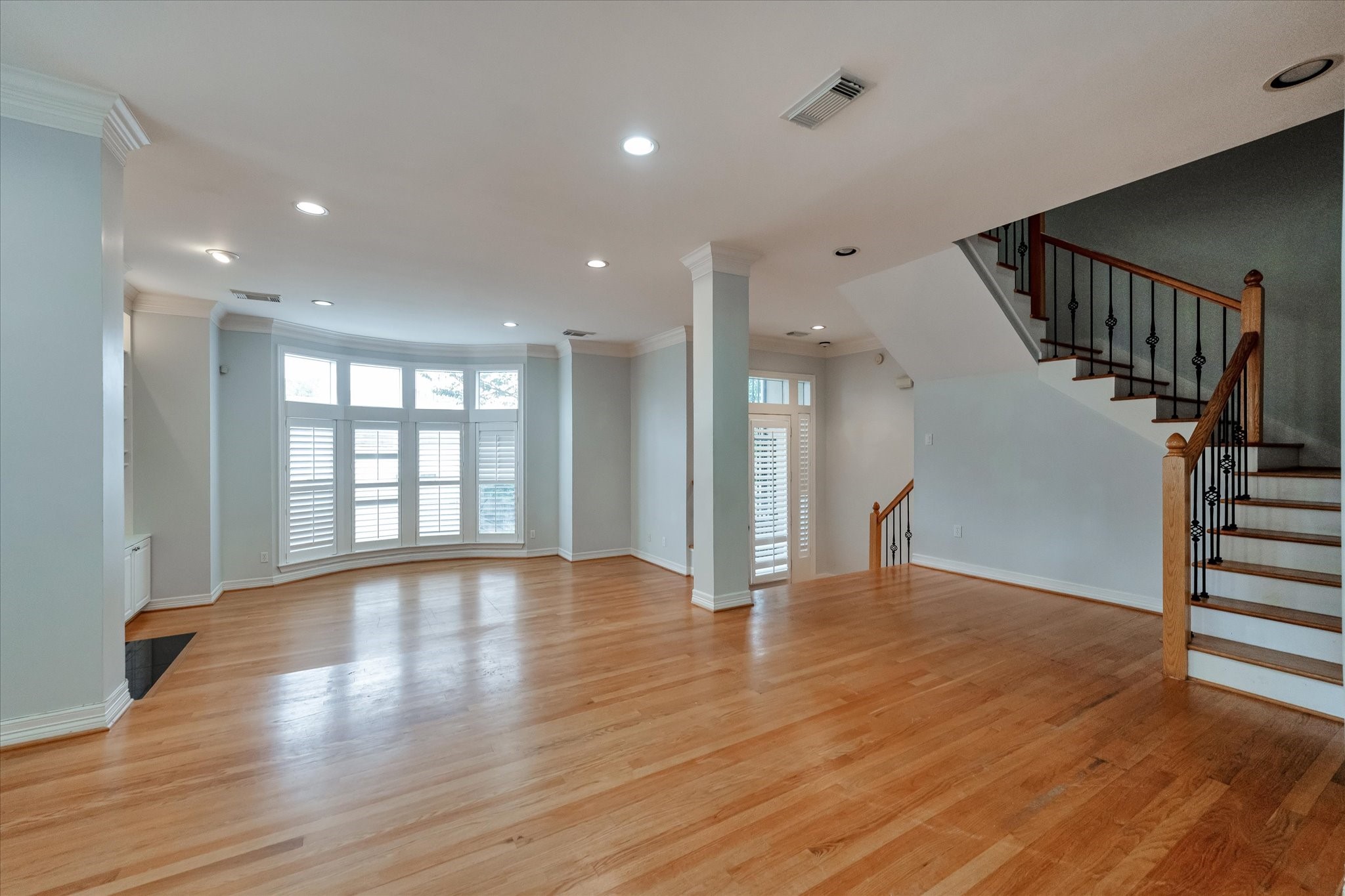 Take a look at this opposite angle of your dining room without virtual staging. This frame showcases about 80% of the flow for the 2nd floor. Going through from your entrance to your living area and dining room, then showcasing the beautiful stairwell that leads you to the third floor.