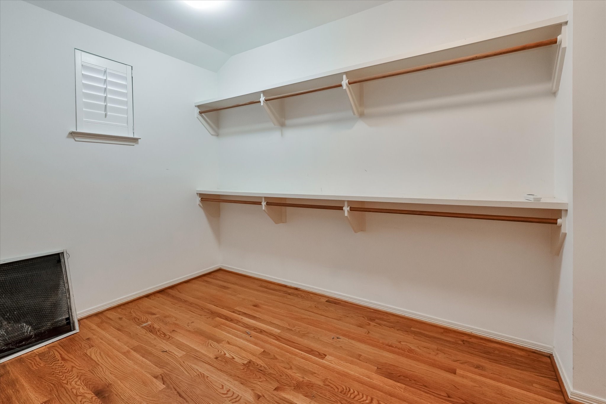 Take a look at your extra large primary walk-in closet equipped with plenty of hanging racks and shelving.
