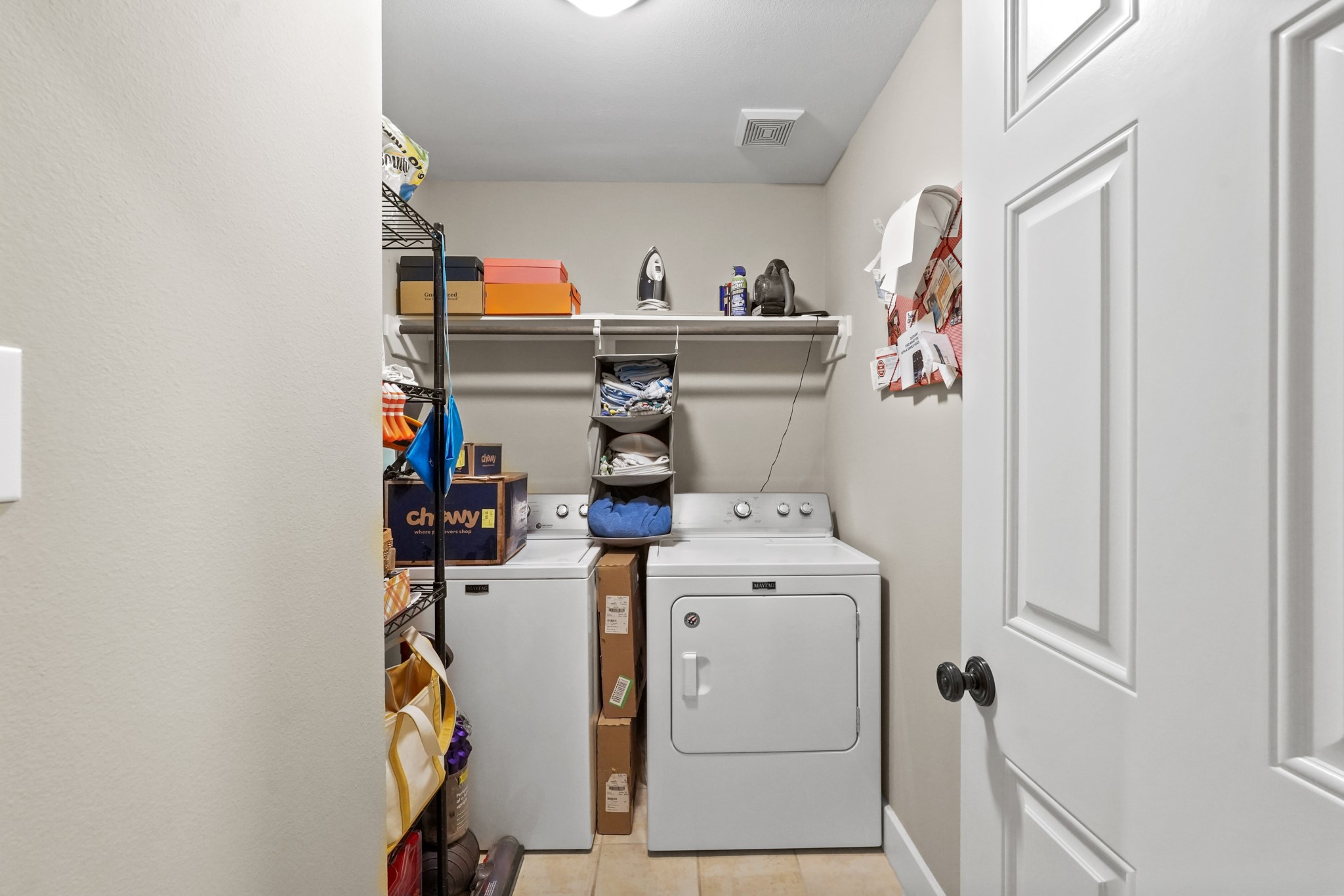 Nearby is this spacious laundry room with additional storage space.