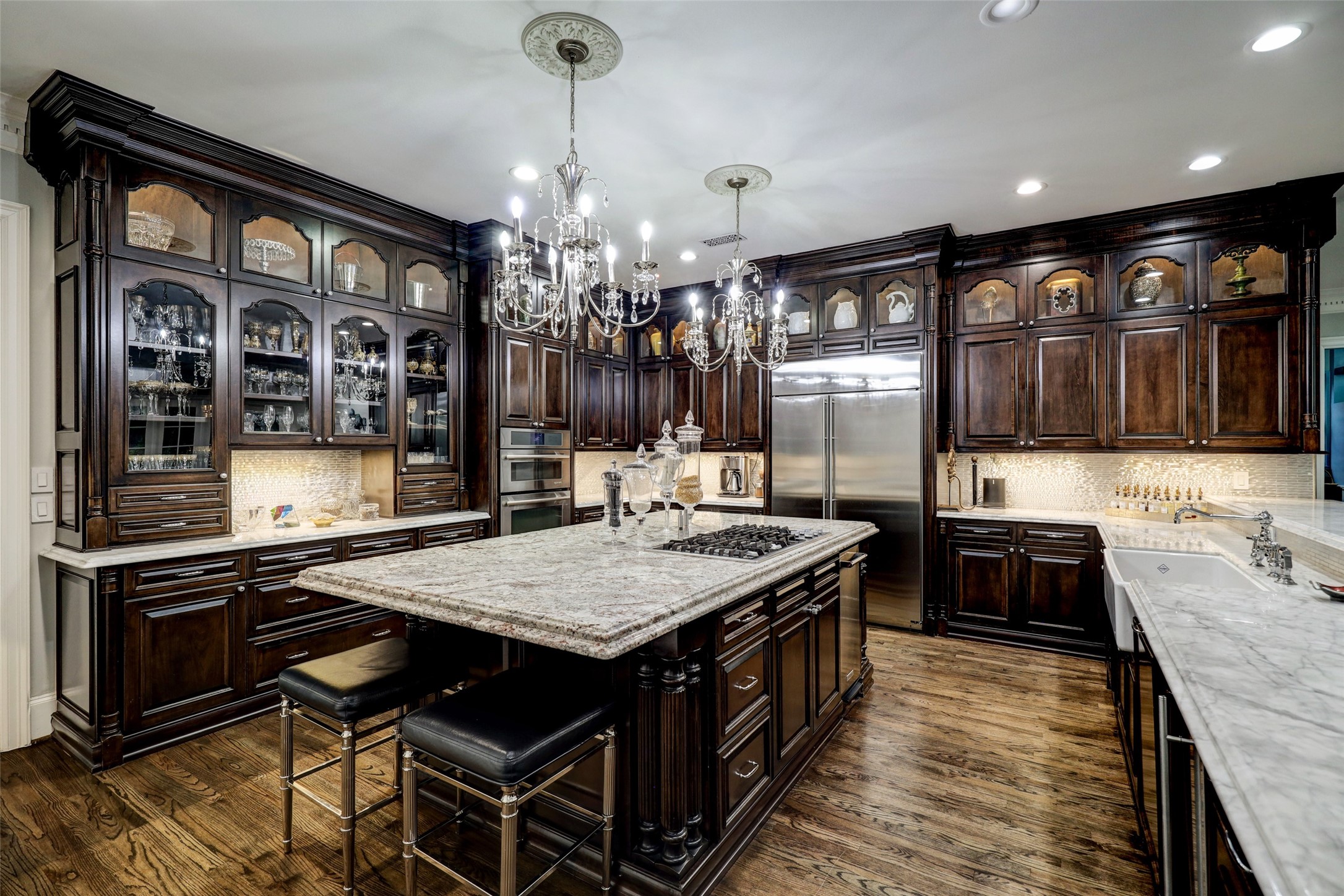 The Kitchen upper cabinets are lighted and feature glass paned doors so that you can display your treasures. Also within this space are a 'Sonic' ice machine, recent Monogram side-by-side Refrigerator, drawer-style Microwave, and updated cabinet lighting.