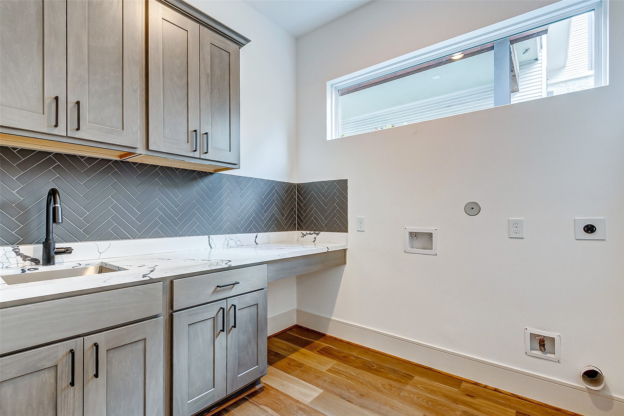 The oversized utility room is accommodating to a large front or top load washer and dryer and features additional room for a secondary fridge!