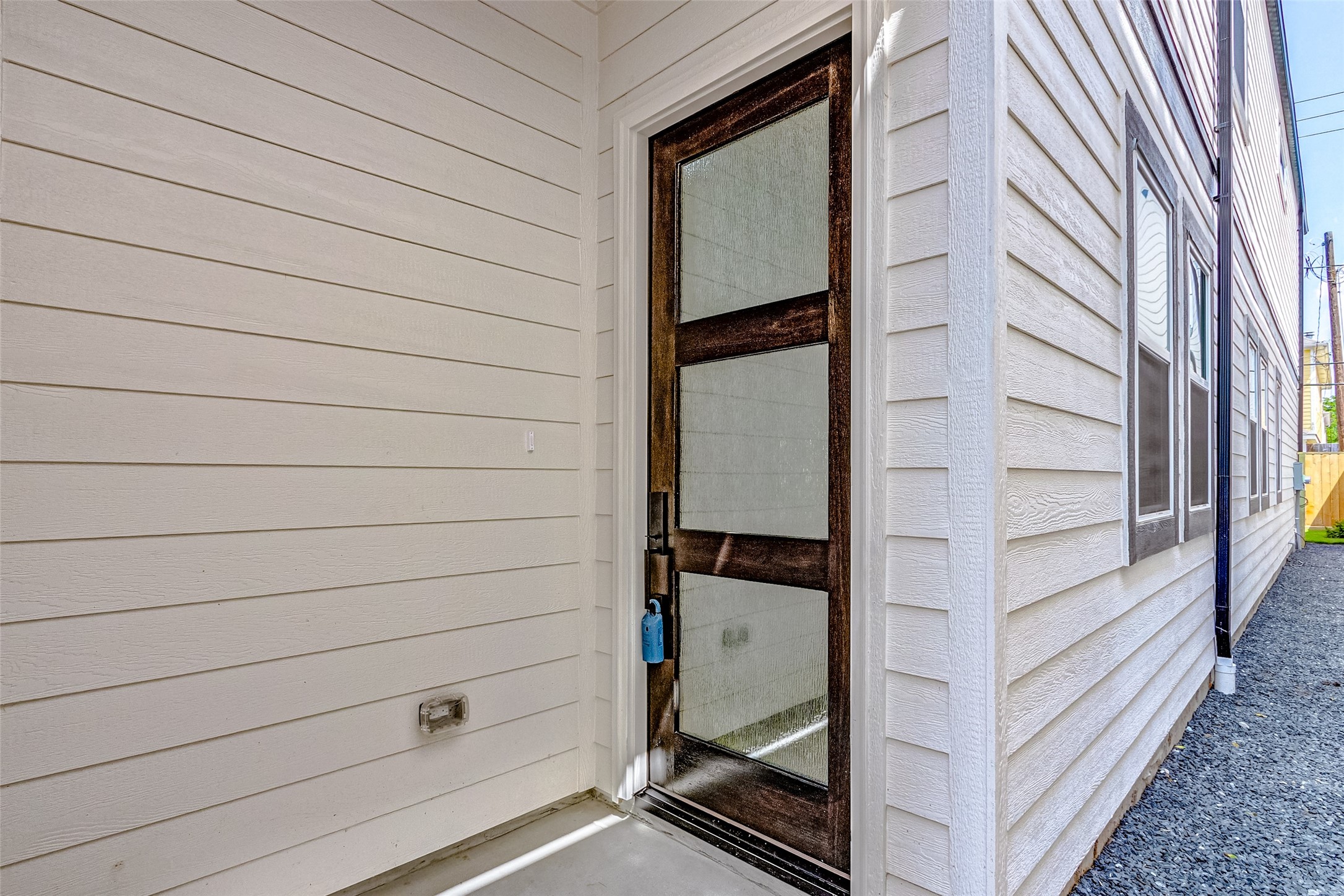 A modern door with obscure window inserts allows natural light to fill your front foyer.