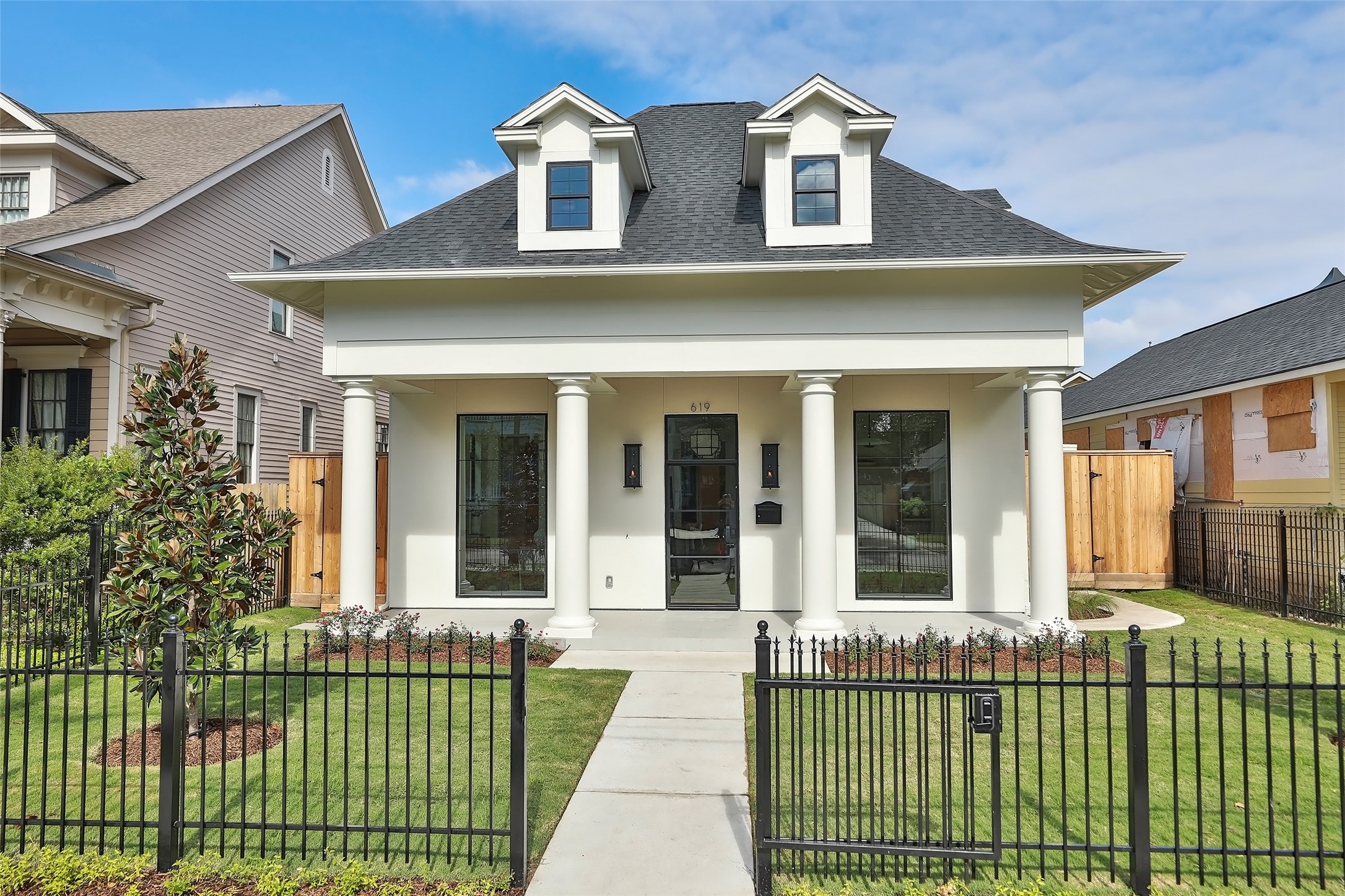 The front yard is enclosed with a wrought iron gate that locks, newly landscaped with two (2) southern Magnolia Trees. Tiled walkway leads to a large covered front patio with two elegant gas carriage lights and custom front door.