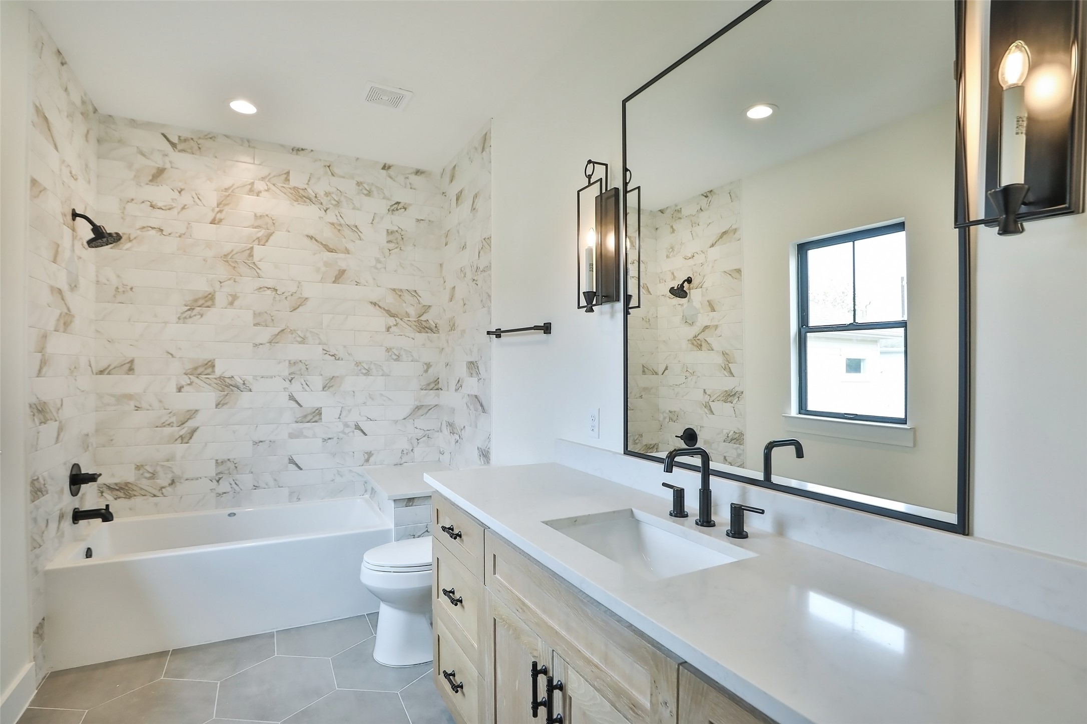 This full bathroom is located on the second floor in the back of the home adjacent to the large room.