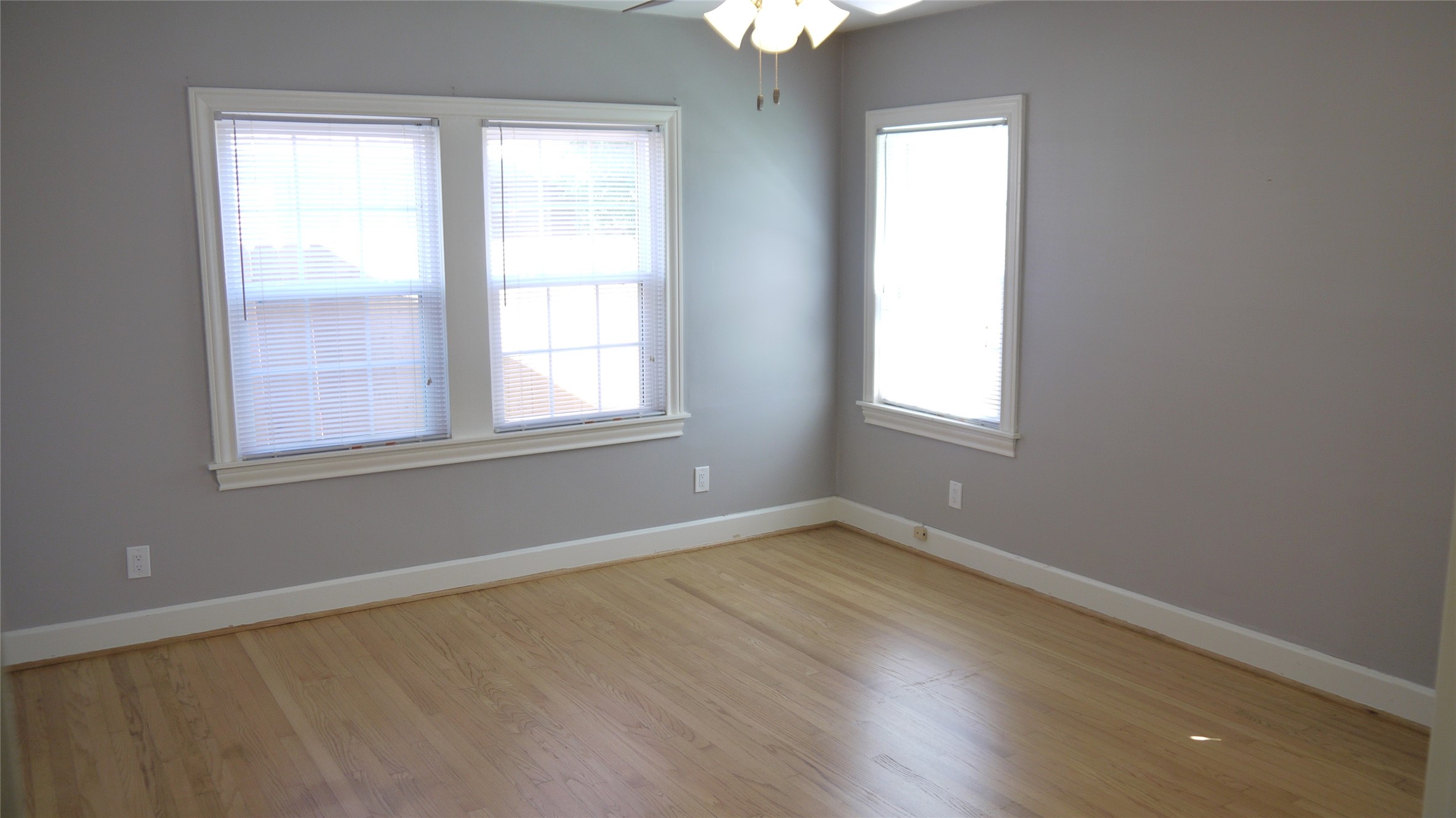 Your back bedroom with an abundance of windows and again the nicely redone hardwoods.