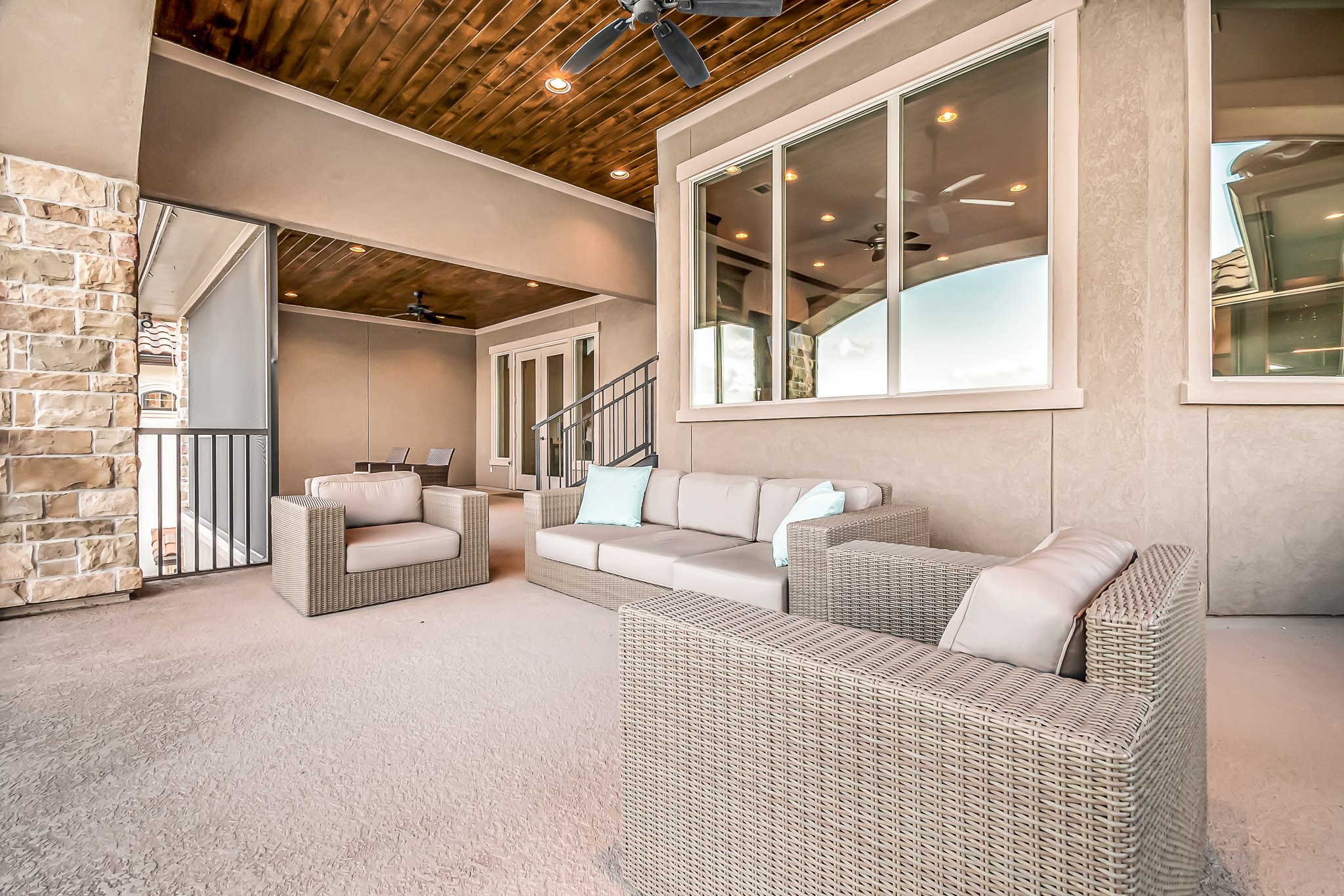 The second floor balcony provides several seating areas and is screened in for an enjoyable outdoor experience. Wood plank ceiling adds to the custom design of this home. Access this balcony from the game room or second floor office.