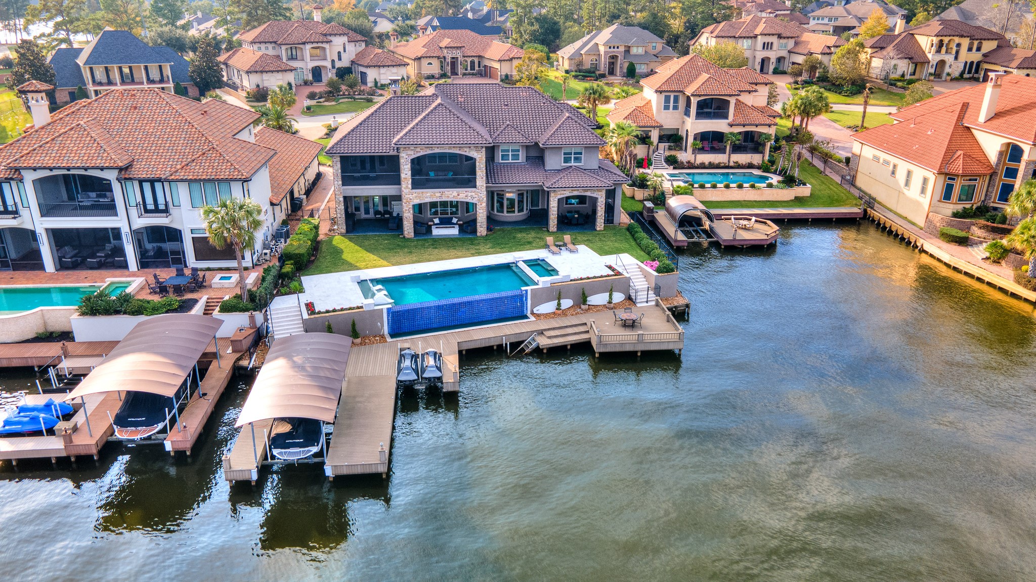 Composite decking for a low maintenance outdoor space expands across 100 feet of bulkhead. Enjoy a dual jet ski lift and boat lift to conveniently store your water toys.