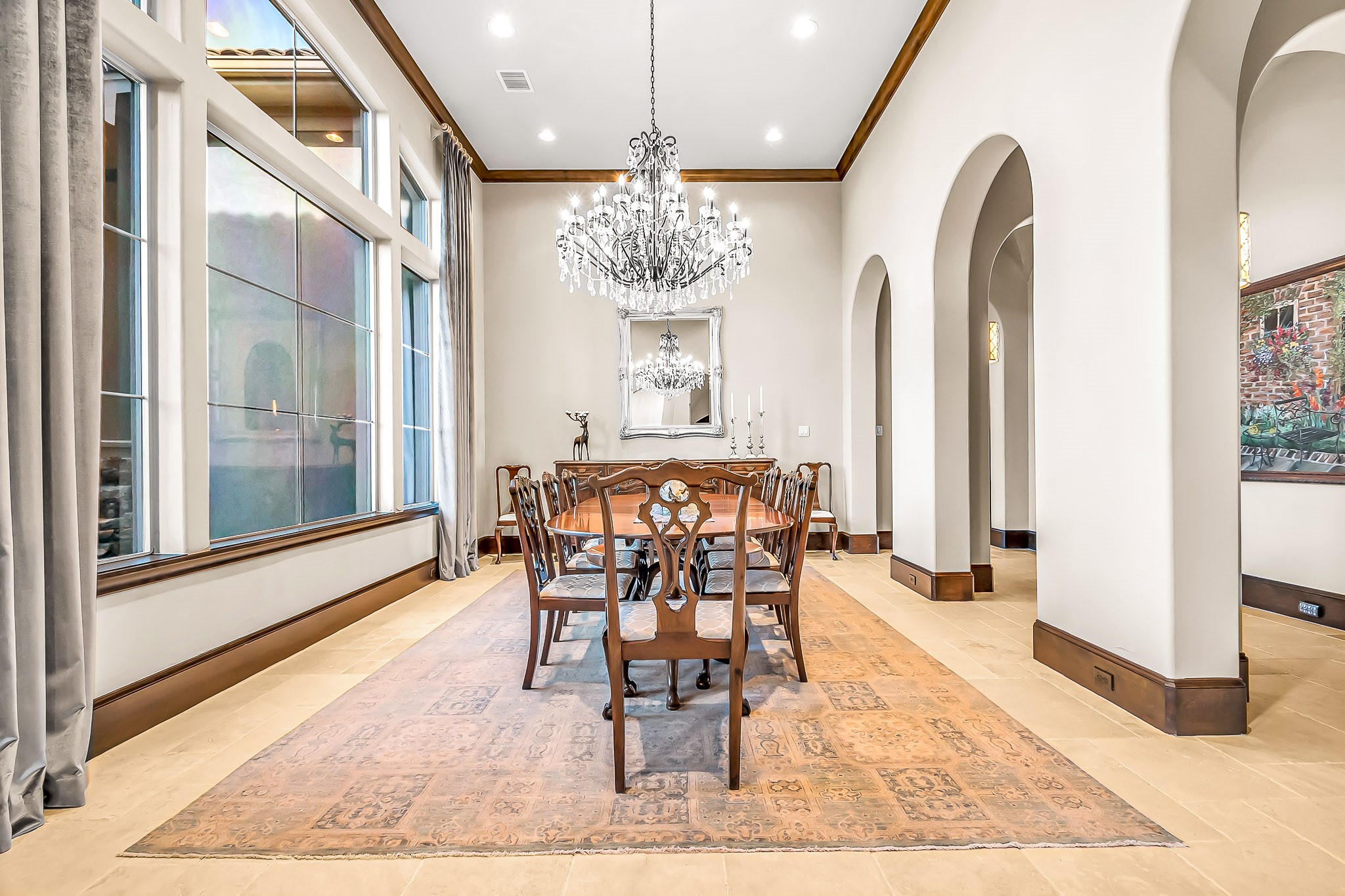 The stately formal dining room has a gorgeous chandelier centered over dining space large enough to accommodate larger groups and multiple furniture pieces.