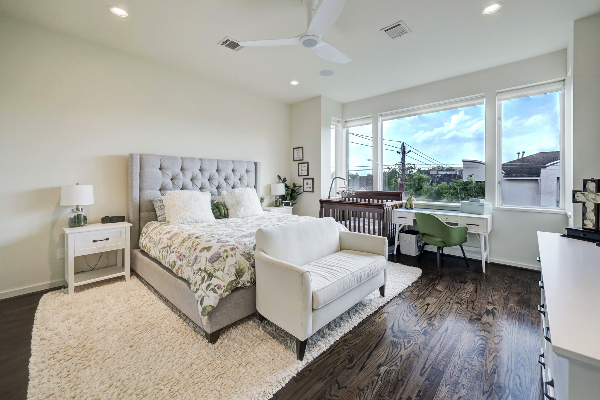 Primary bedroom is to die for. Hardwood floors, large windows, high ceilings and three closets