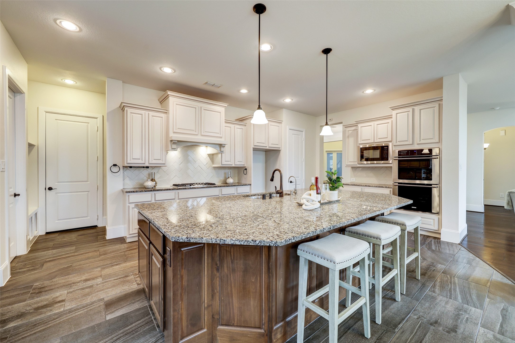 A haven of culinary possibilities with its tasteful palette, oversized island and stainless appliances, the eat-in kitchen is the heart of this home.