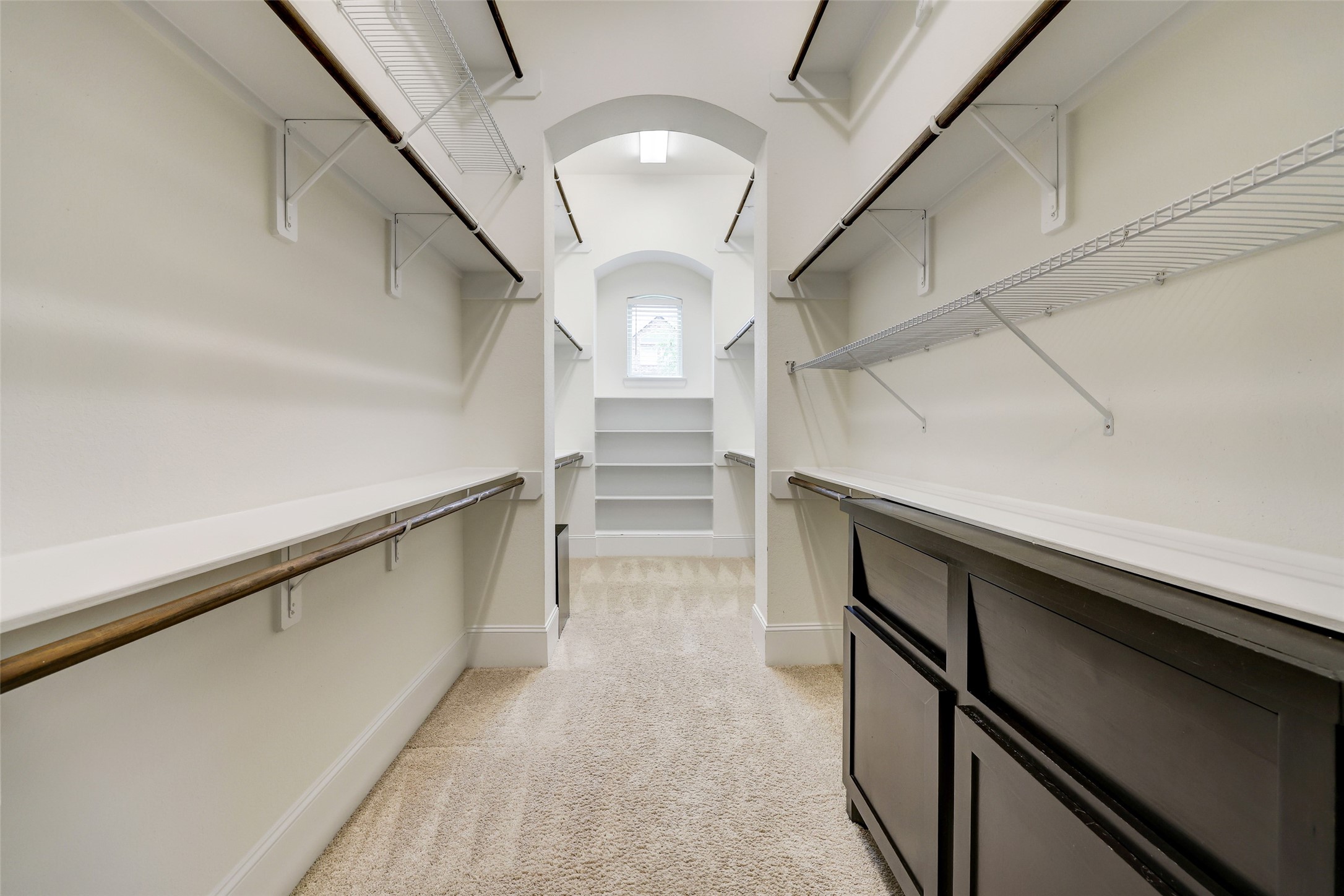 The Primary Suite closet offers built-ins, ample hanging space and additional overhead storage.