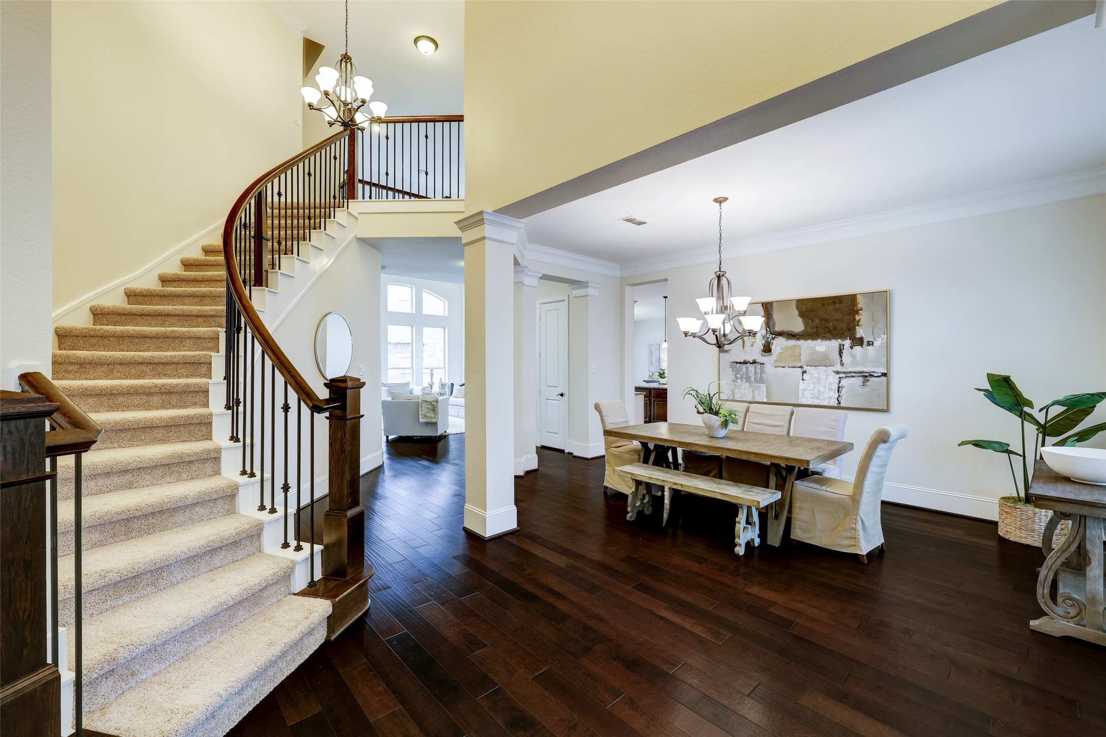Elegance welcomes you home in the foyer, with rich wood floors and a freshly painted neutral palette guiding the way to a lifestyle of comfort and sophistication.