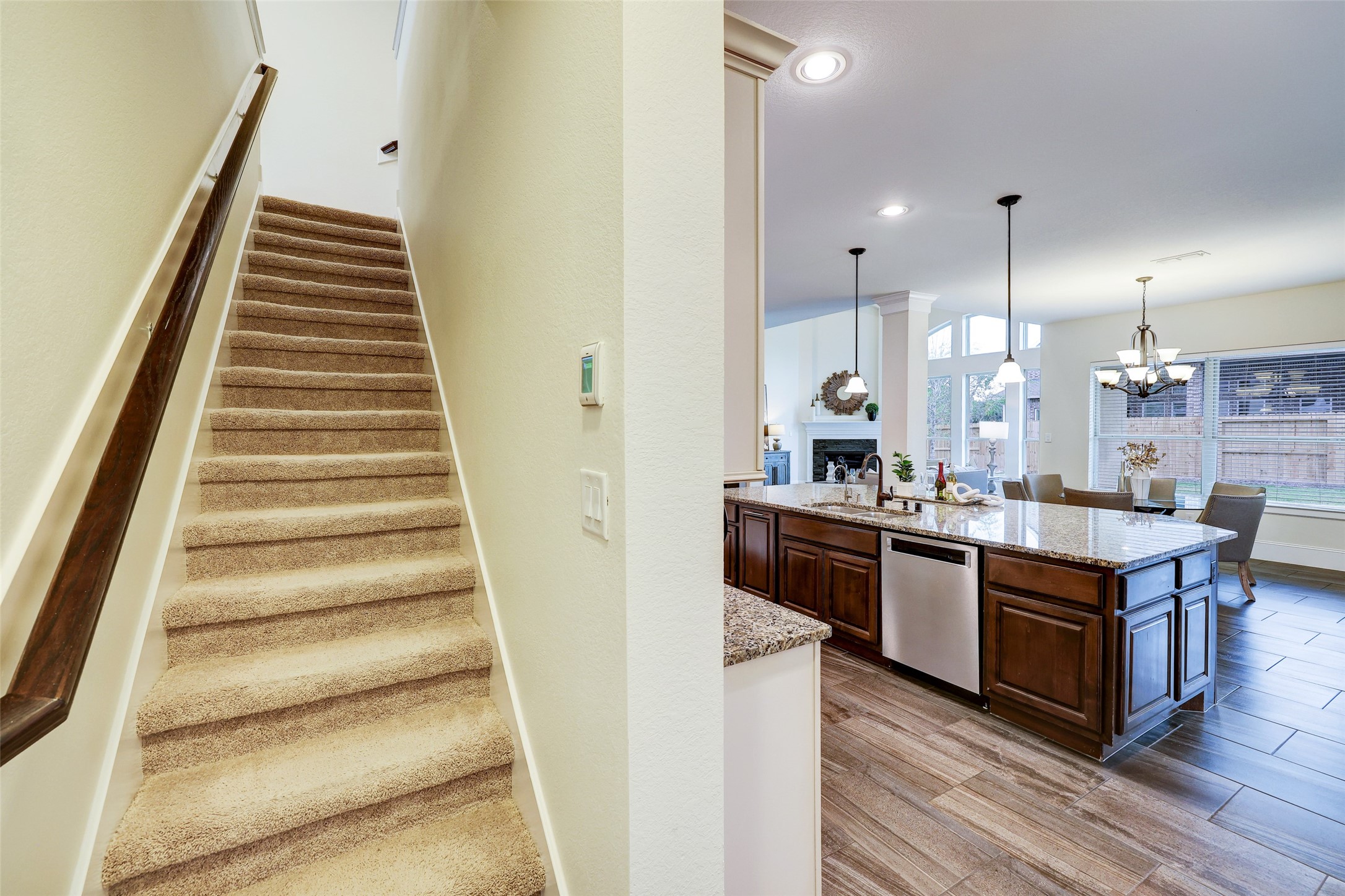 Tucked privately behind the kitchen is a second staircase for convenience and ease of access from the garage.