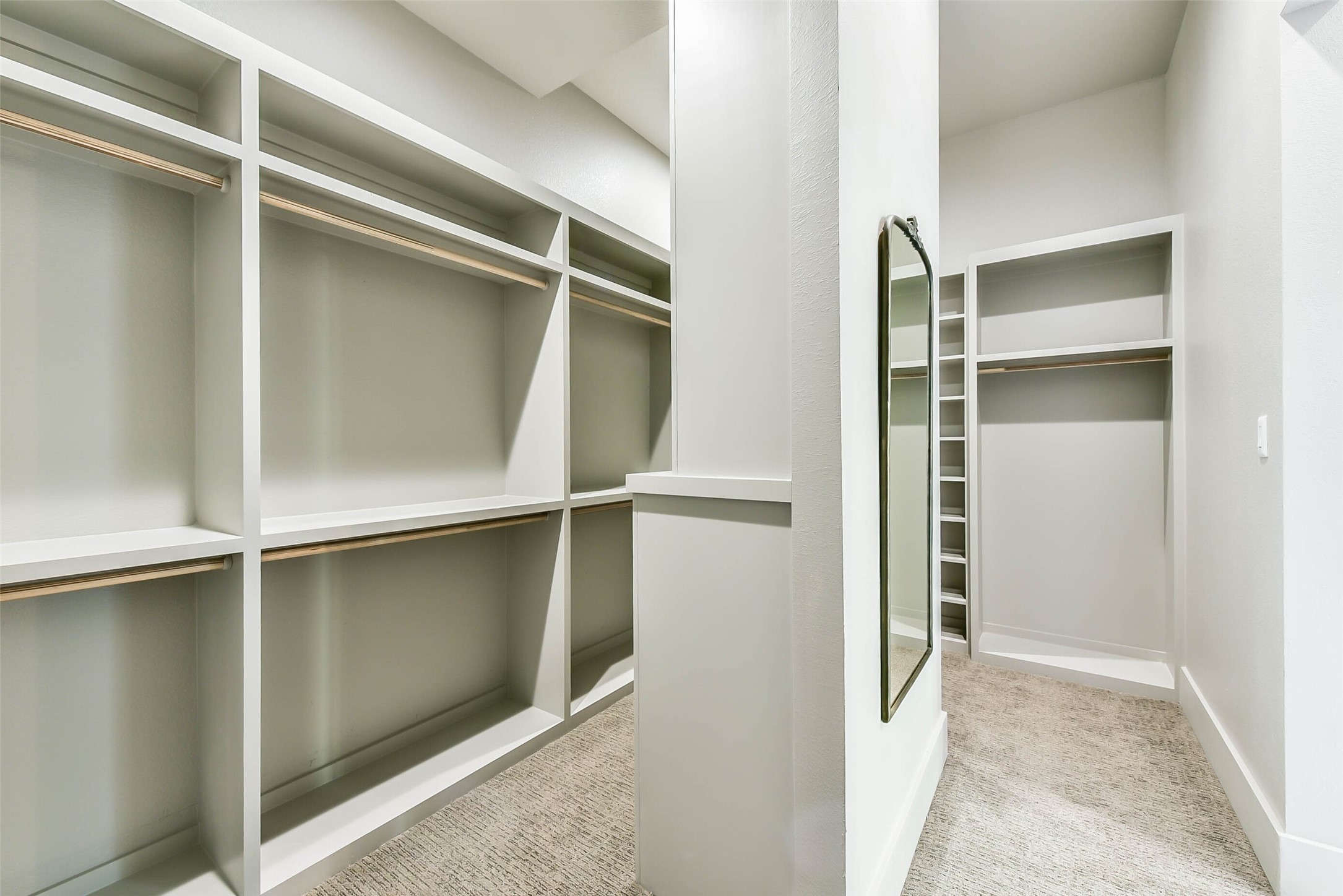 The large walk-in closet provides ample space in the custom built-ins for all of your personal belongings.
