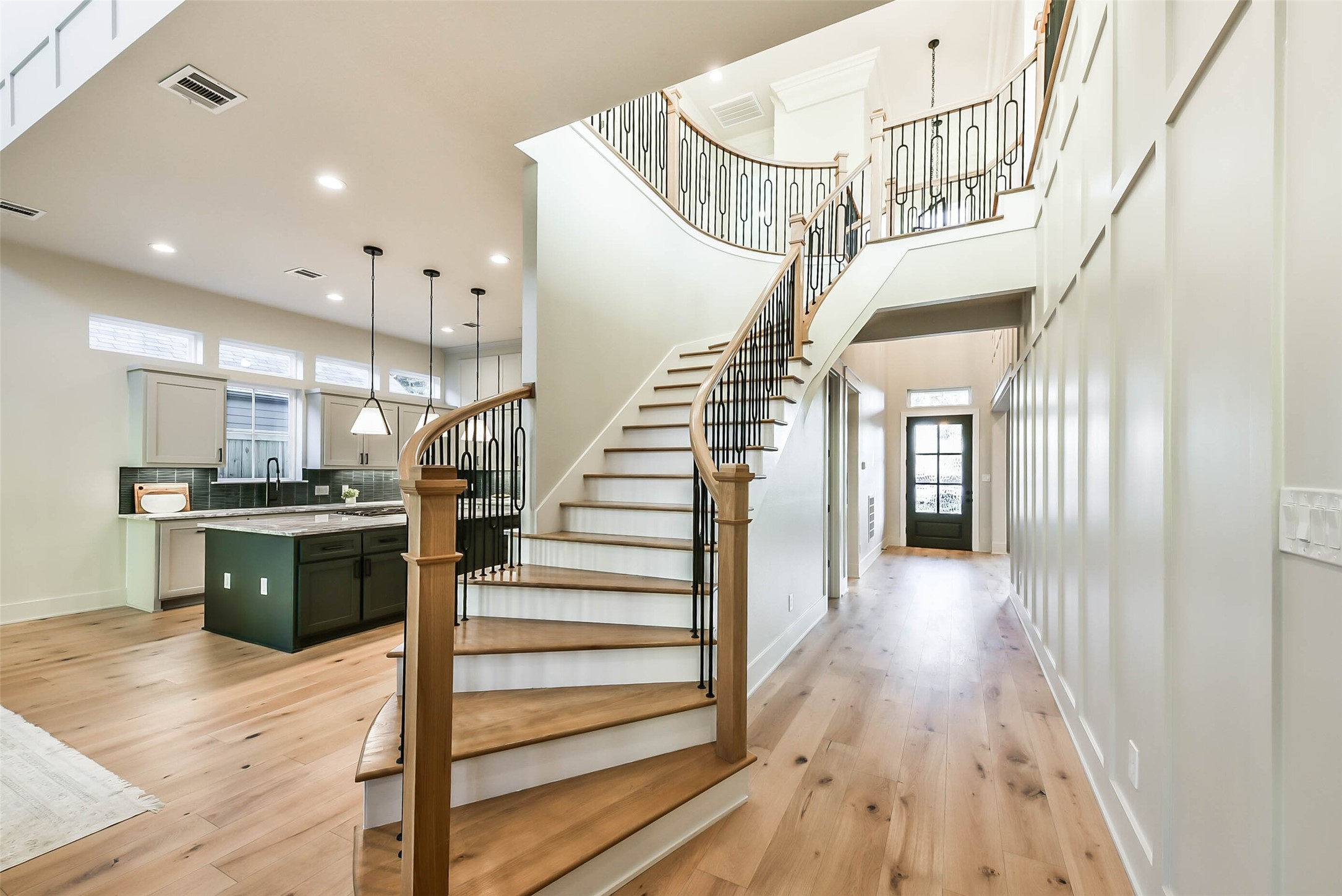 The elegant staircase with white oak treads invites your guests and family upstairs to the large game room and additional bedrooms.