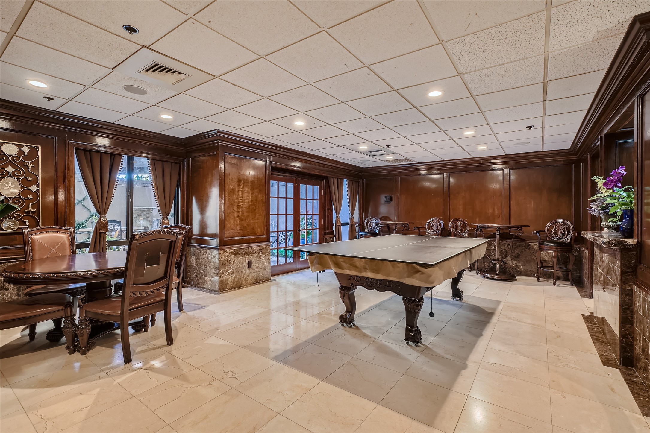 Entertain and unwind in style in the game room, complete with a lounge area, a wet bar, and a table for a game of cards.