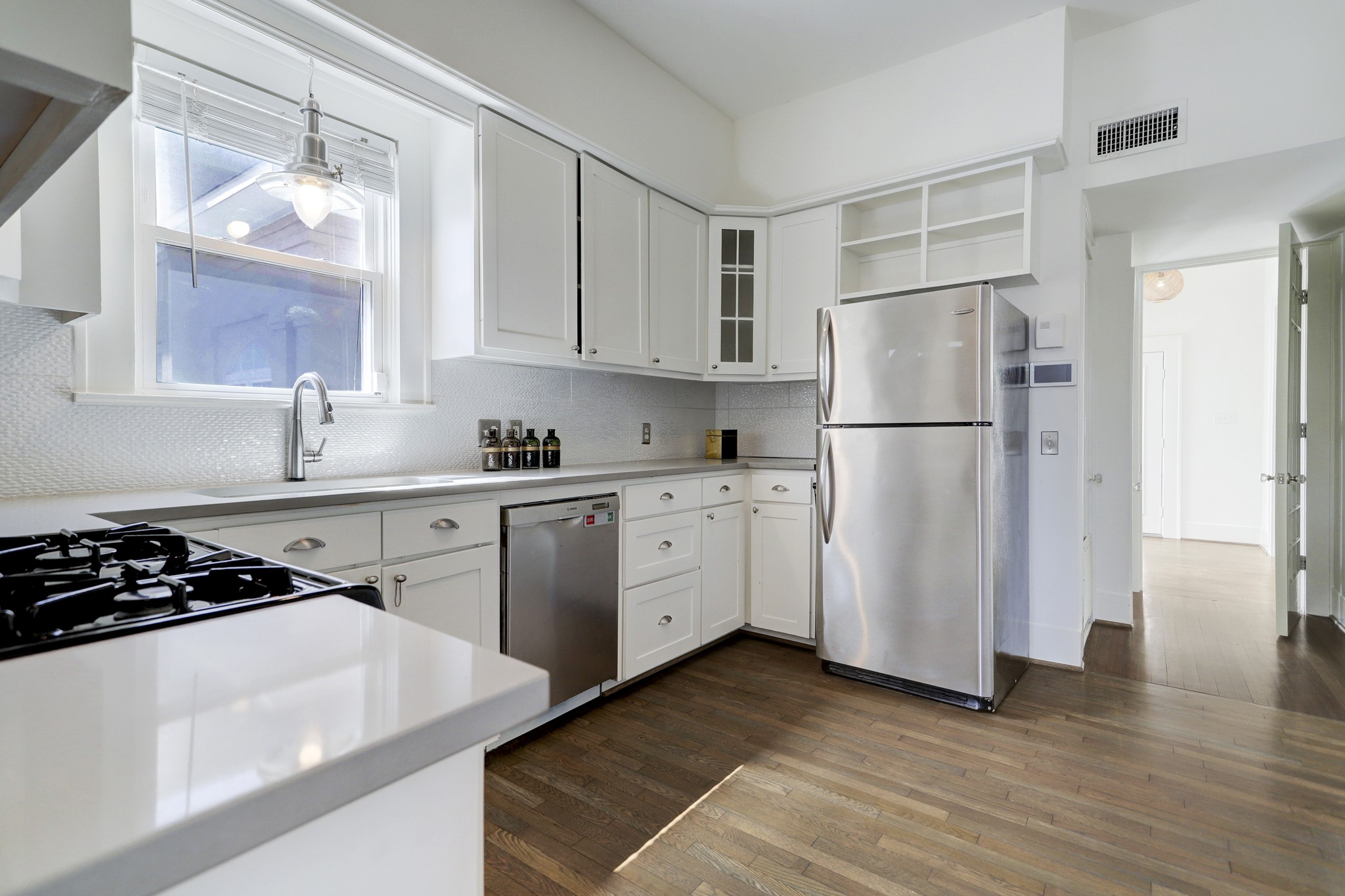 WITH PLENTY OF CABINET SPACE, GRANITE COUNTERTOPS AND CUSTOM BACKSPLASH, THIS KITCHEN HAS BEEN EQUIPPED WITH A BEAUTIFUL STAINLESS APPLIANCE PACKAGE!