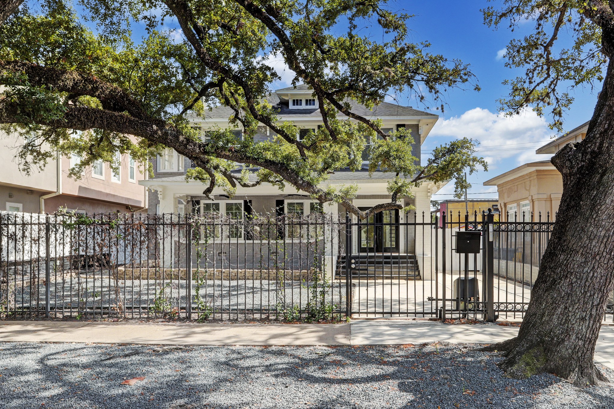 SURROUNDED BY MAGNIFICENT, MATURE OAK TREES, THE PRESENCE OF THIS HOME IS JAW DROPPING AND WILL MAKE ANY HOME OR BUSINESS A SANCTUARY! THE PROPERTY IS WRAPPED IN AN ELEGANT WROUGHT IRON FENCE AND AUTOMATIC SECURITY GATE. A LOW MAINTENANCE FRONT YARD WITH STABILIZED GRAVEL PROVIDES AMPLE PARKING.
