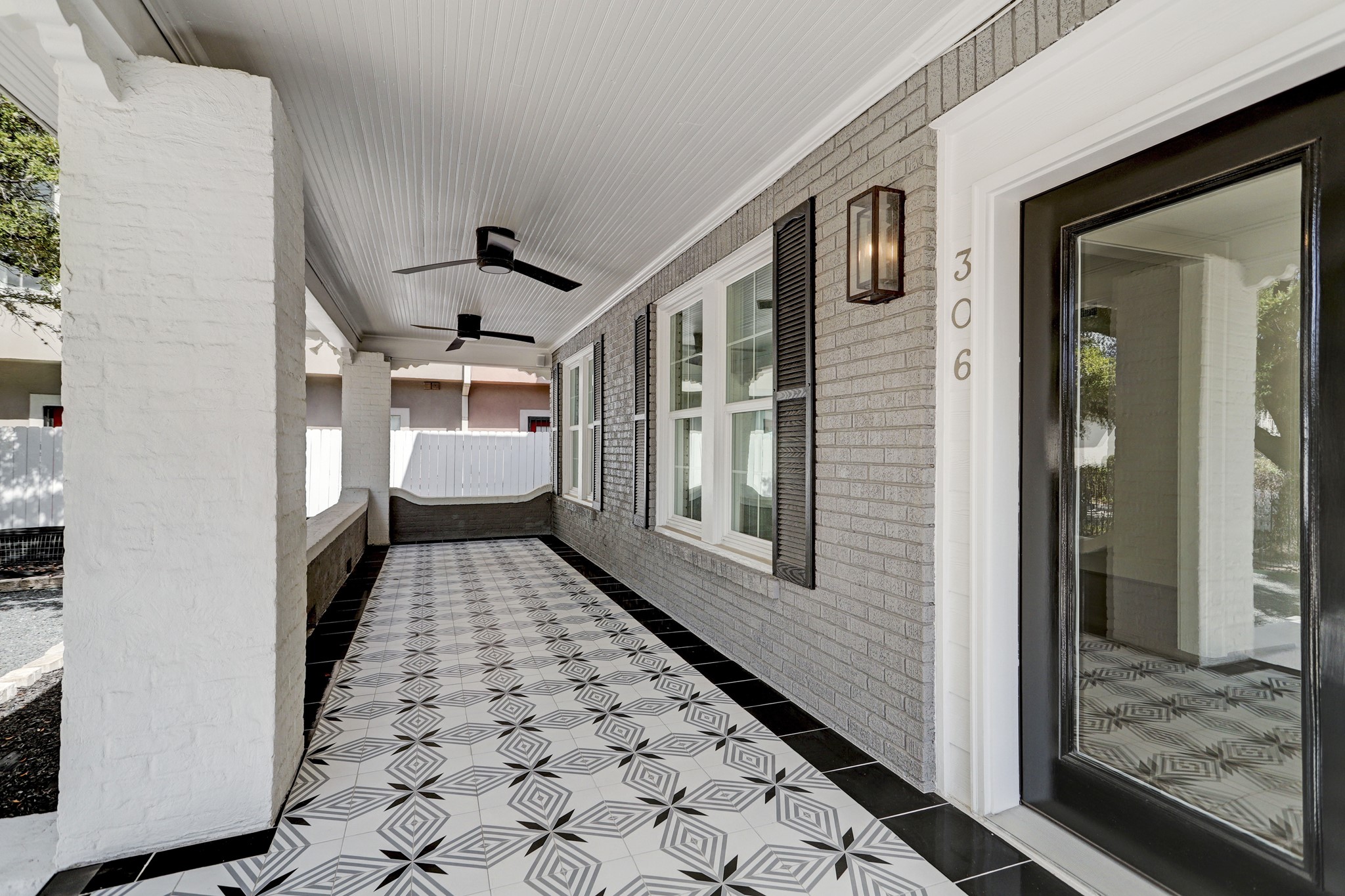THIS CUSTOME TILE WORK WILL GREET YOU AND YOUR GUESTS ON APPROACH TO THE FRONT DOOR! THE FRONT PORCH IS ACCENTED WITH MODERN CONTEMPORARY FANS TO HELP WITH THOSE WARM SUMMER MONTHS.