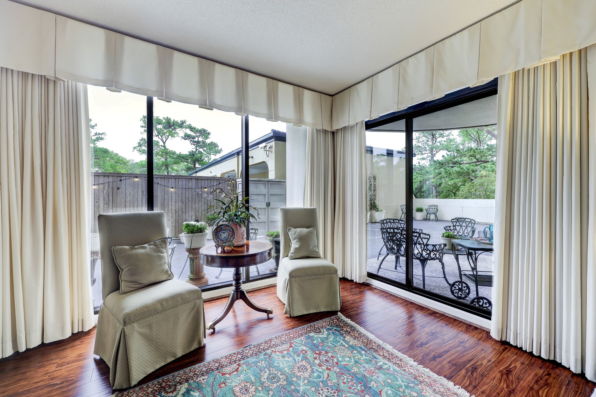 Seating area that brings the outdoor in with full-length sliding glass doors and windows