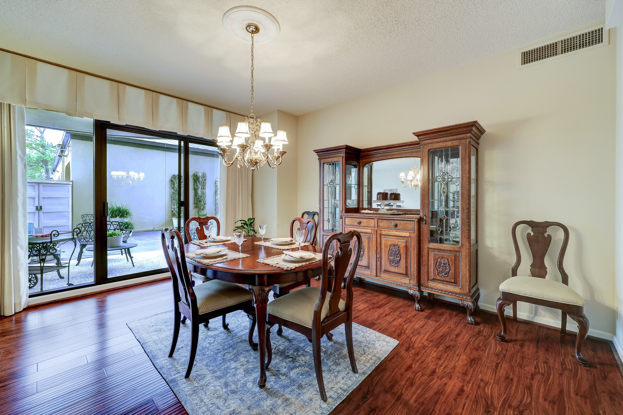 Dining area with plenty of space for China cabinet and table that can be extended with multiple leaves.