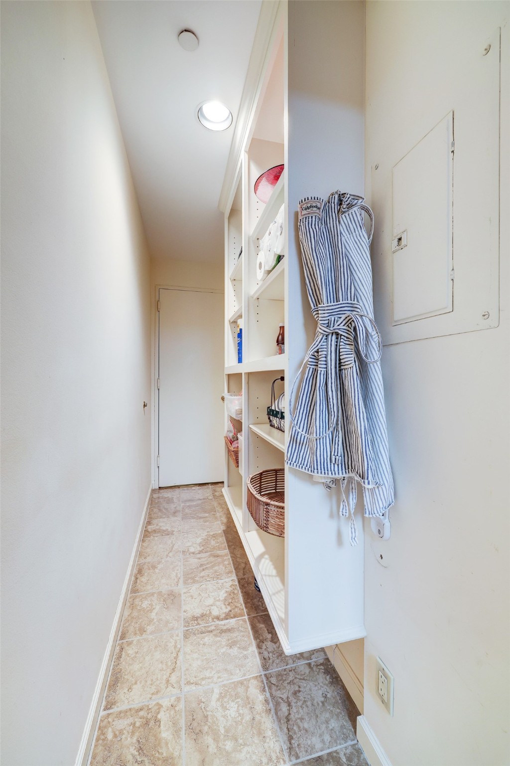 Walk in pantry with built in shelves to make organization easy and accessible