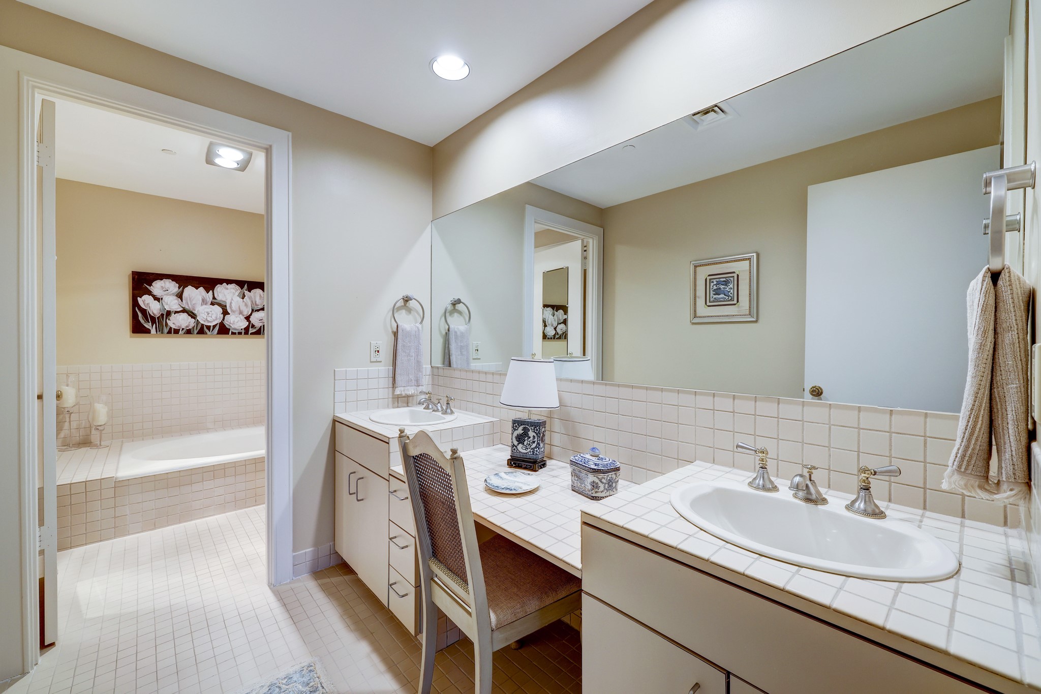 Ensuite bathroom in third bedroom includes double sinks, garden tub and linen closet