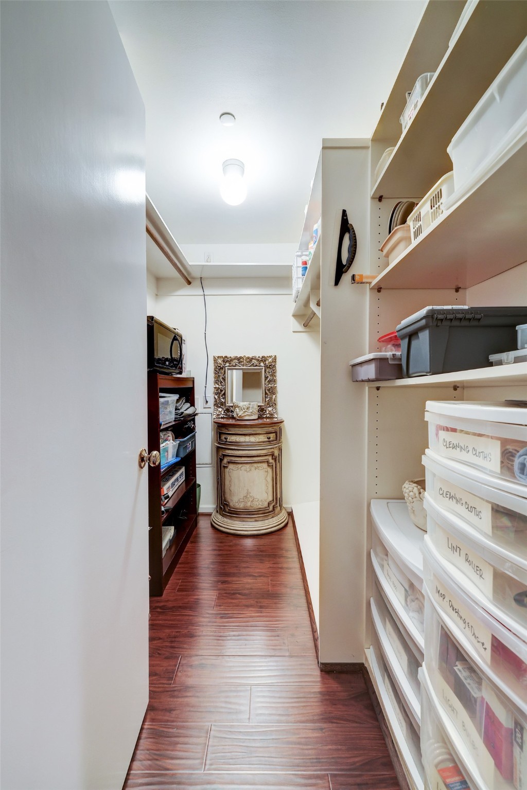 Storage closet off of main hallway with built in shelves and two hanging areas.