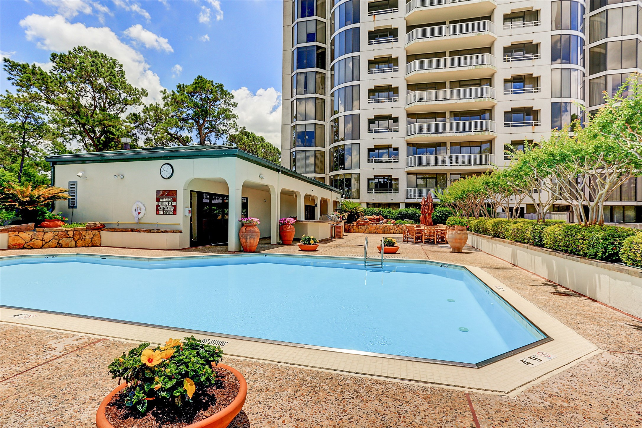 Tealstone Pool area with fire pit, table seating, club room, and exercise room.