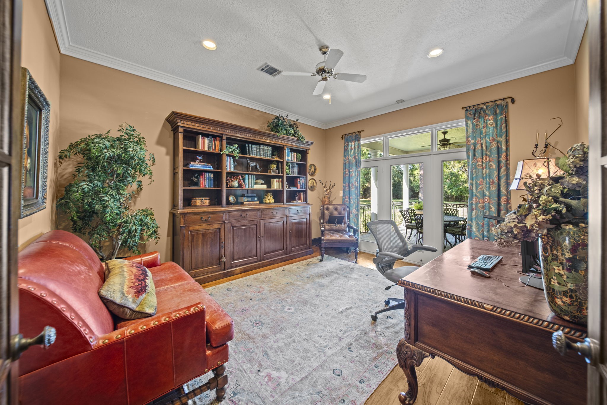 Work from home in this spacious Home office/Study. Doors lead to the exterior back covered patio.