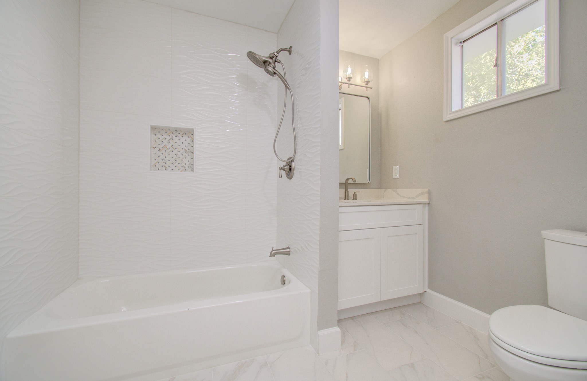 The guest hallway bathroom includes a tub/shower and new washer/dryer connections and drainage for an indoor laundry room!