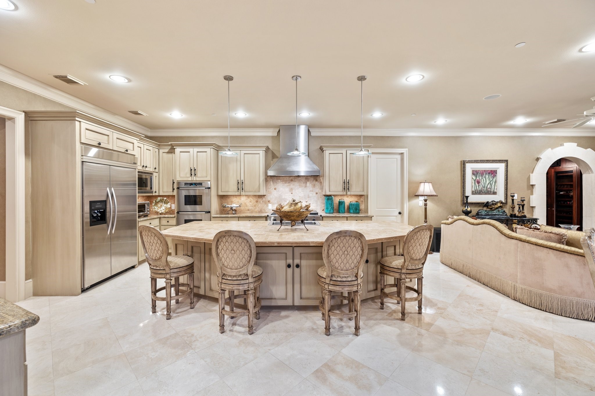 The grand kitchen with full bar seating, open floor plan, stainless steel appliances and granite countertops is filled with oversized windows that bathe the space in natural light.