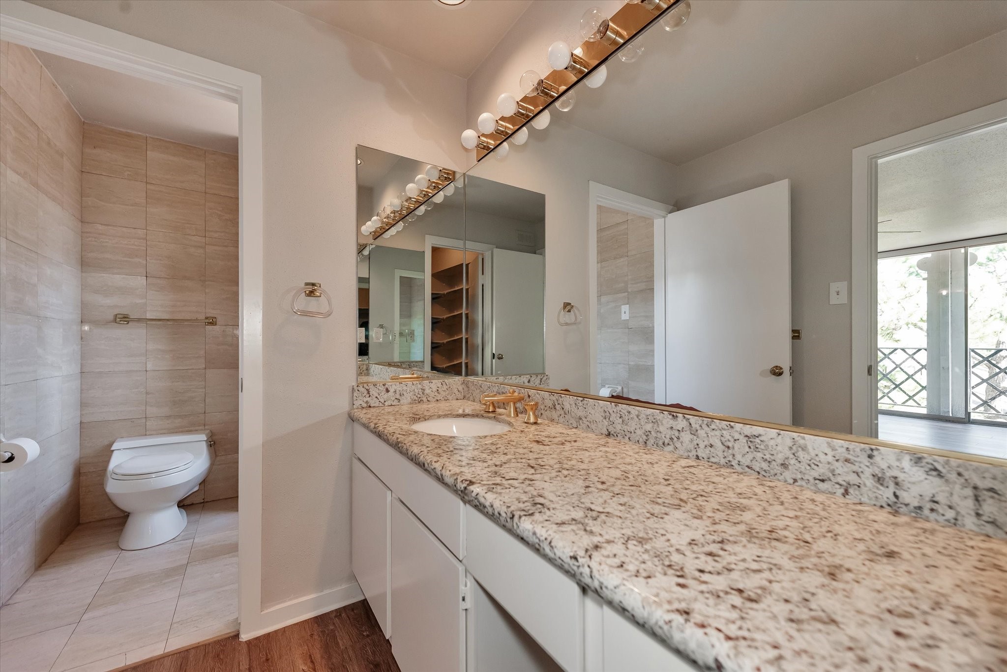 Primary bath with lovely granite counter and huge mirror.