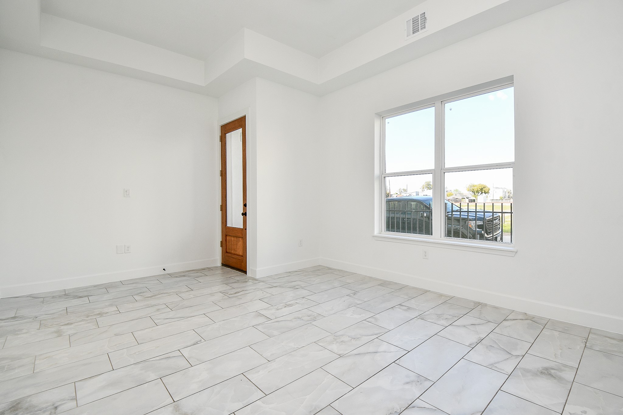 This is the view of your main entrance, from the inside, with cool toned walls, tile flooring and big windows for great natural light. Featured in this gorgeous 3-story home are 3 bedrooms, 3-1/2 baths, occupying a 2,316 square-foot-lot with 2,105 of lush interior living space.