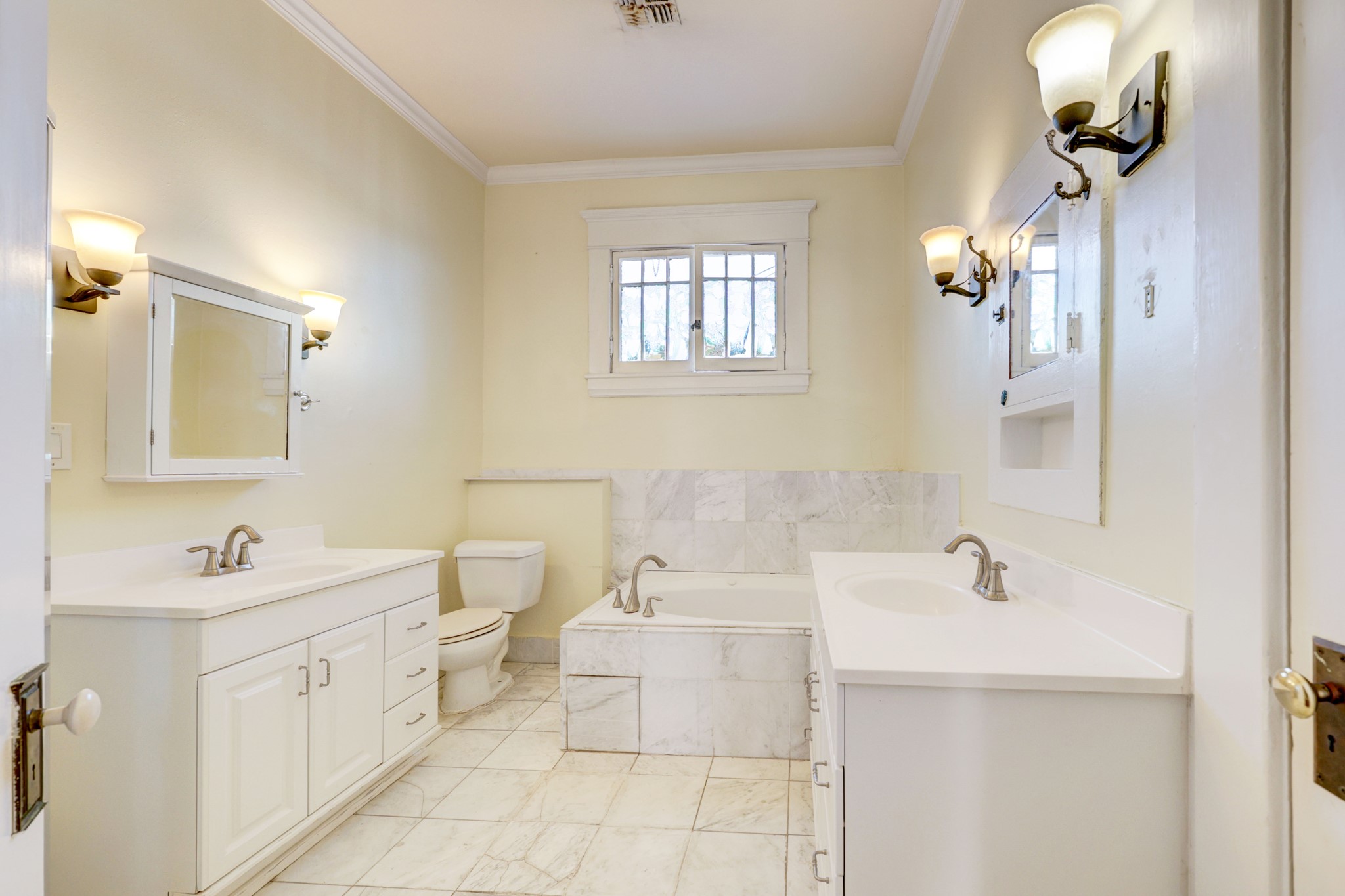 Second level bathroom with dual vanities, soaking tub and separate shower.