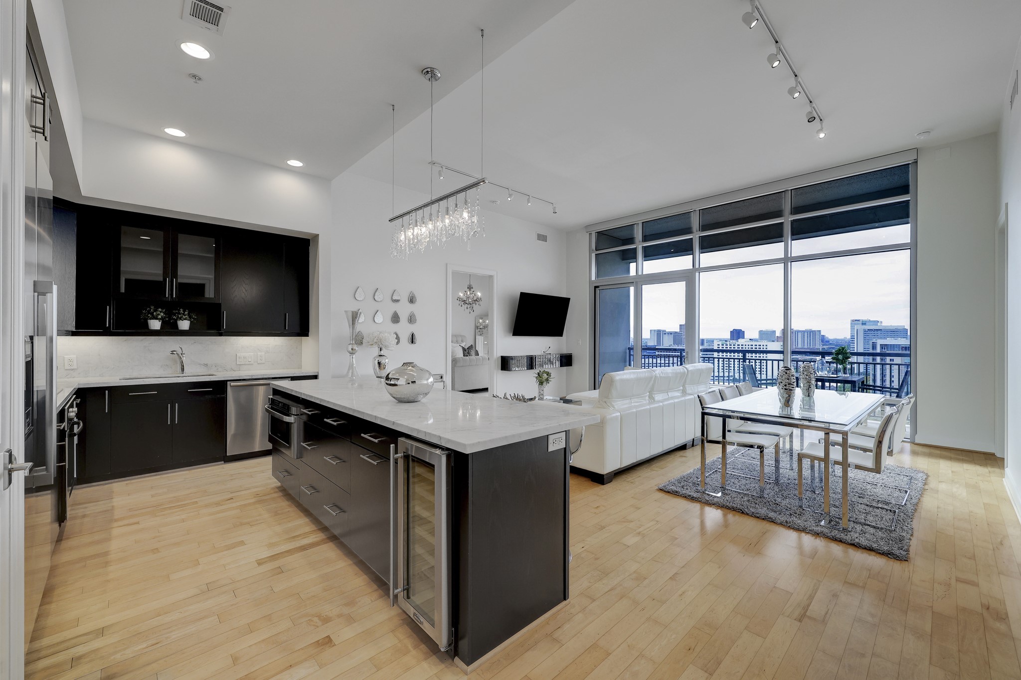 Embrace a luxurious lifestyle in this exceptional penthouse condominium in hidden gem Inner Loop Highland Tower. The furnished residence is a blend of modern elegance with stylish updates including light wood floor, crisp white walls, marble countertops and top of the line appliances.