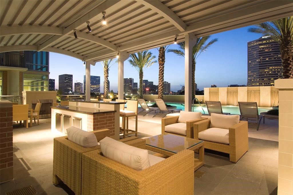 An array of first-class amenities includes a terrace pool with covered seating, outdoor kitchen, outdoor fireplace, lounge, gym and putting green.