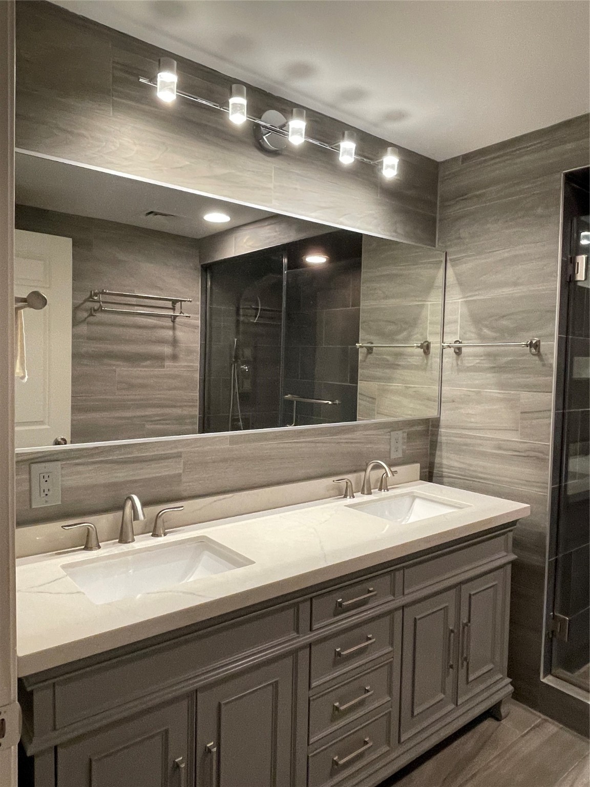 Double-sink vanity in fully ceramic-tiled Master Bathroom