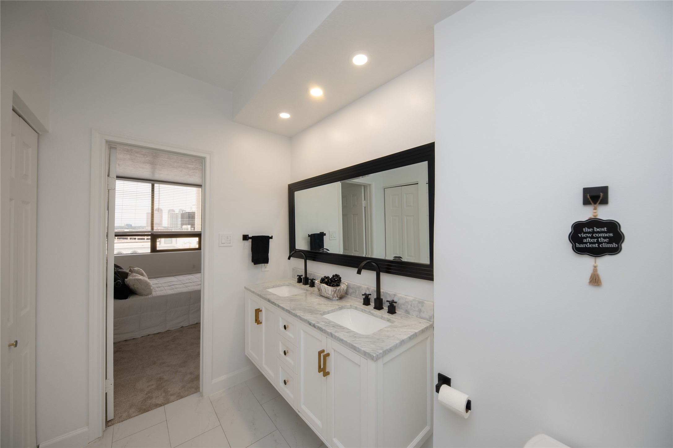 Here is another angle on the beautiful primary bathroom with marble countertops. This well thought out bathroom is sure to delight the discerning buyer looking to make a move into the Galleria area.