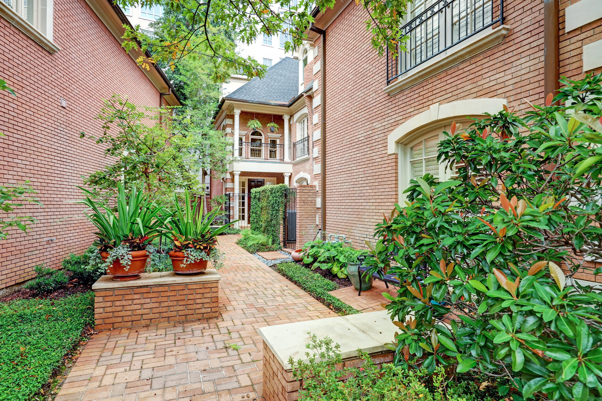 This beautiful brick lined walk way leads you to the entrance of this gracious townhome.