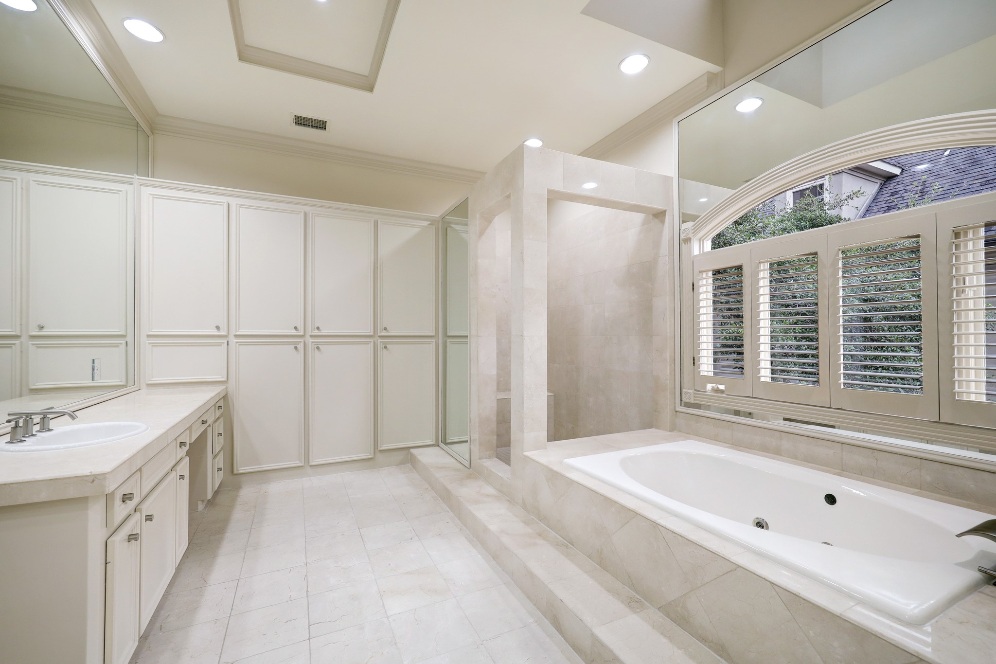 The primary bath offers a relaxing jacuzzi tub and large walk-in shower.