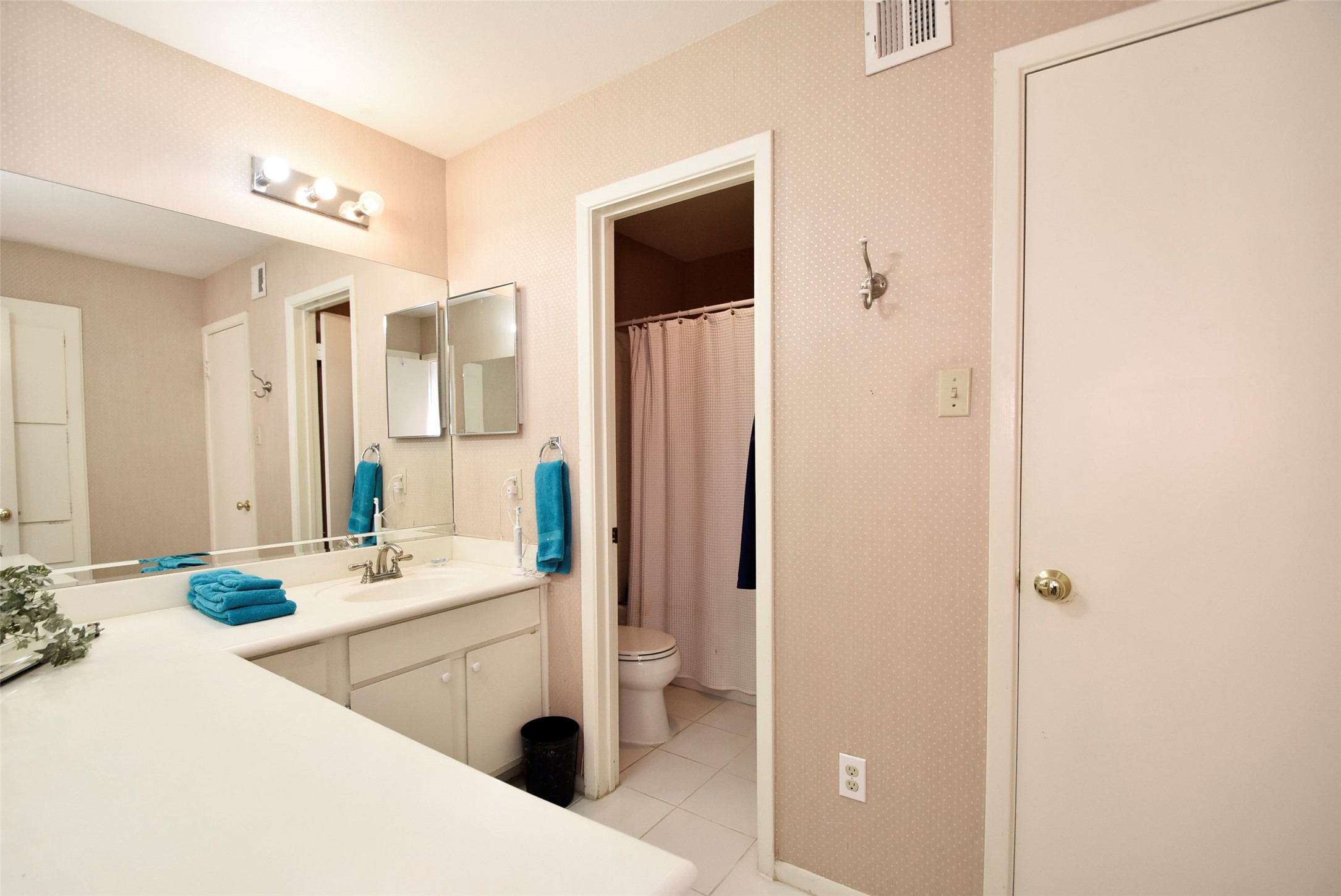 This bedroom has an ensuite bath with a large vanity area and tub/shower.